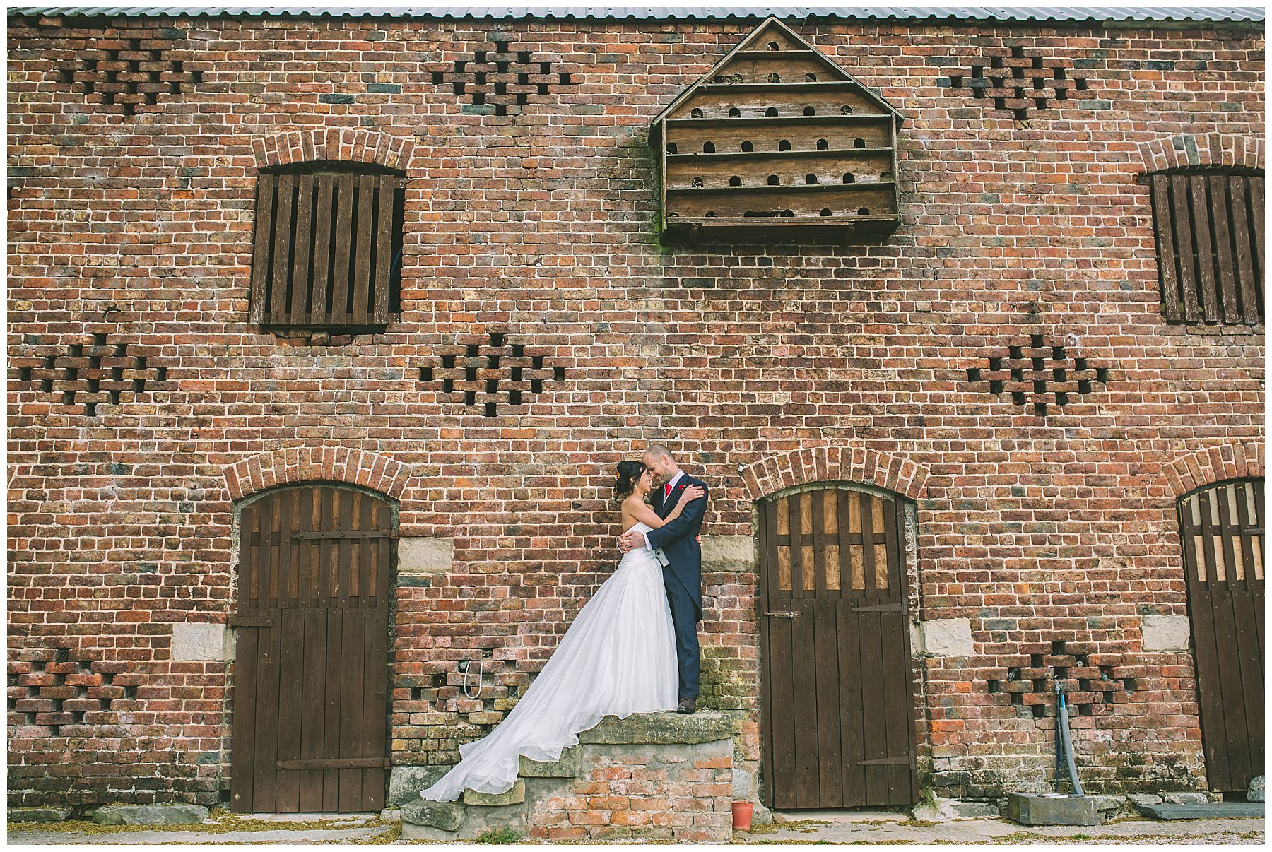 Married couple stand outside of Pentre Mawr on their wedding day