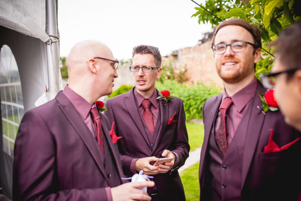 Groomsmen stand chatting