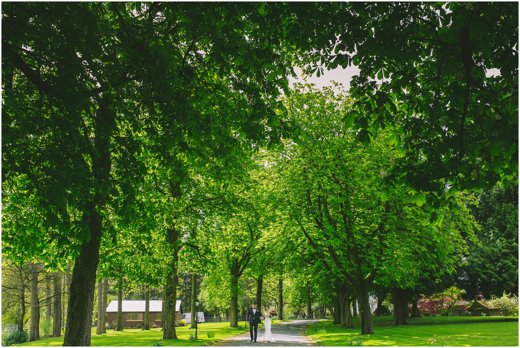 A couple walk up the drive of Colshaw Hall