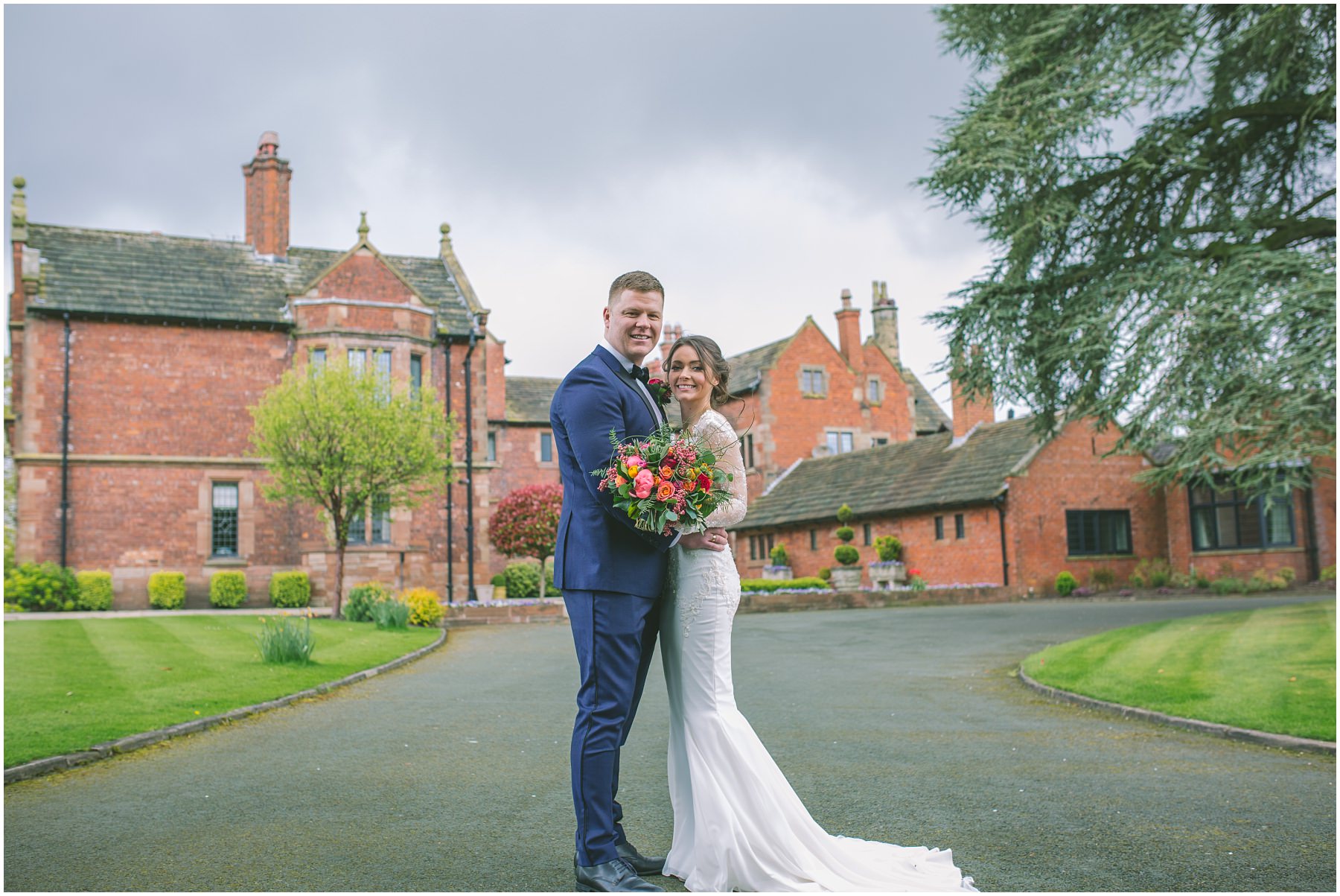 The married couple share an embrace in front of Colshaw Hall