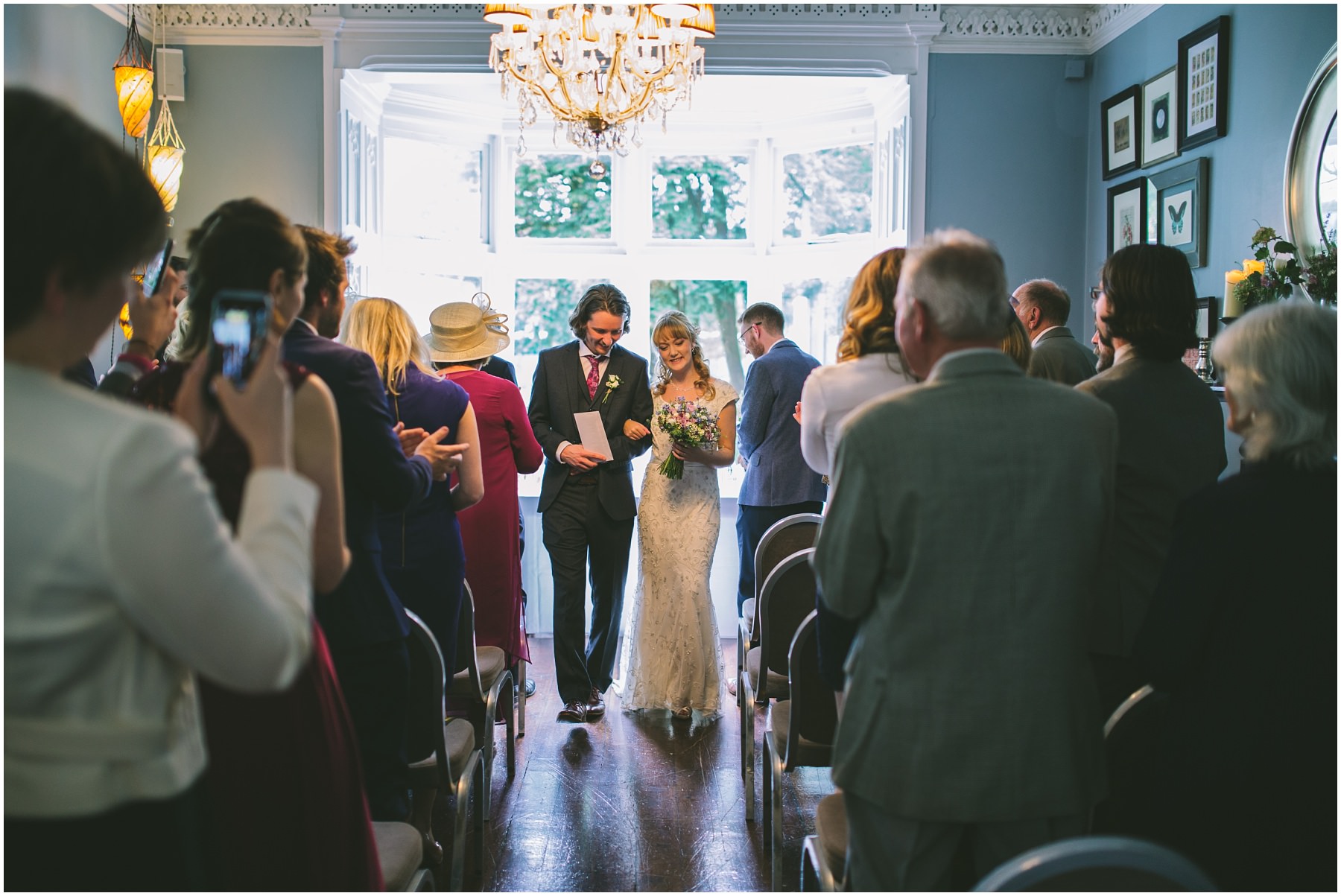 Bride and Groom exit the Blue Room at Didsbury House