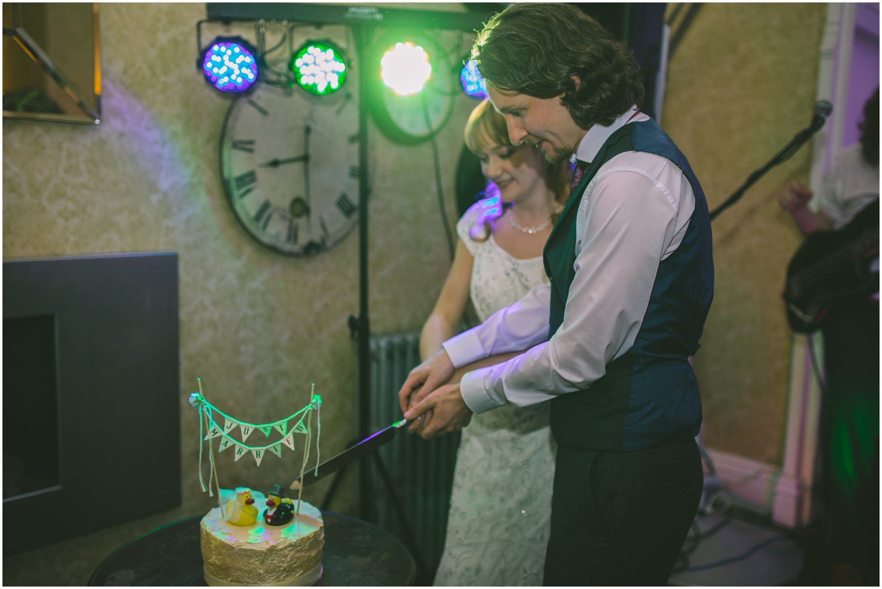 Bride and Groom cut the wedding cake at Didsbury House
