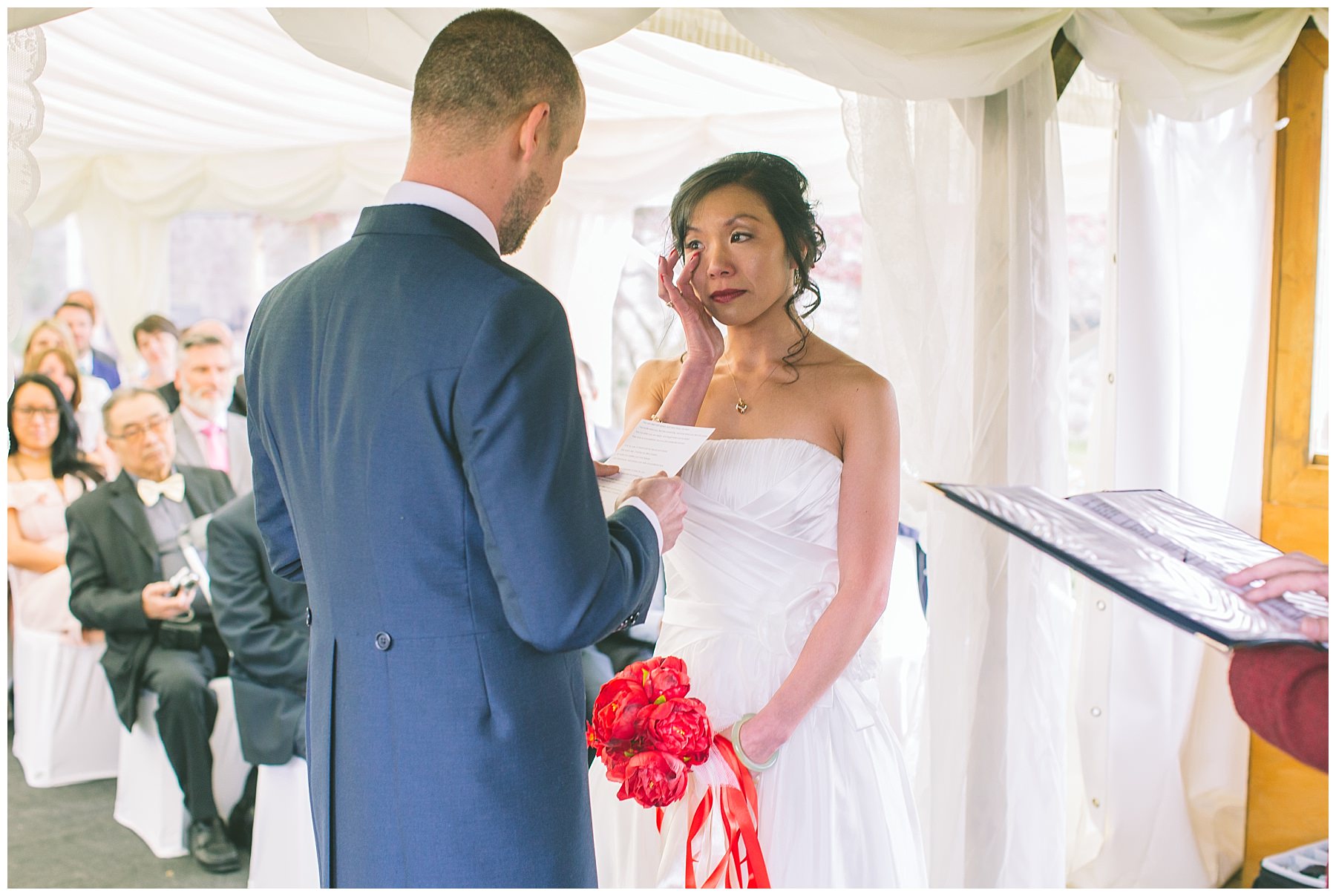 Bride wipes away a tear during ceremony at pentre mawr