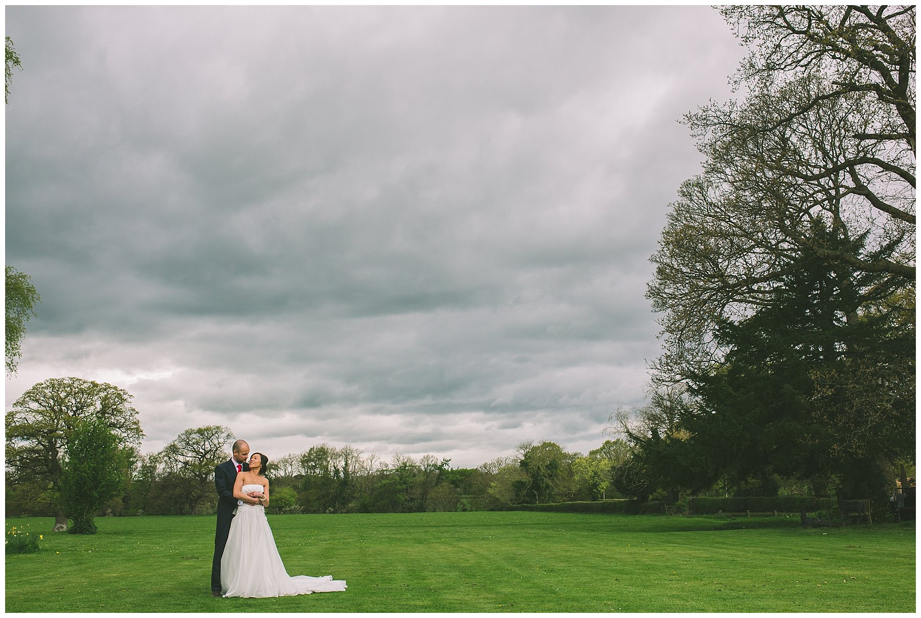 Couple stand in a loving embrace at Pentre Mawr