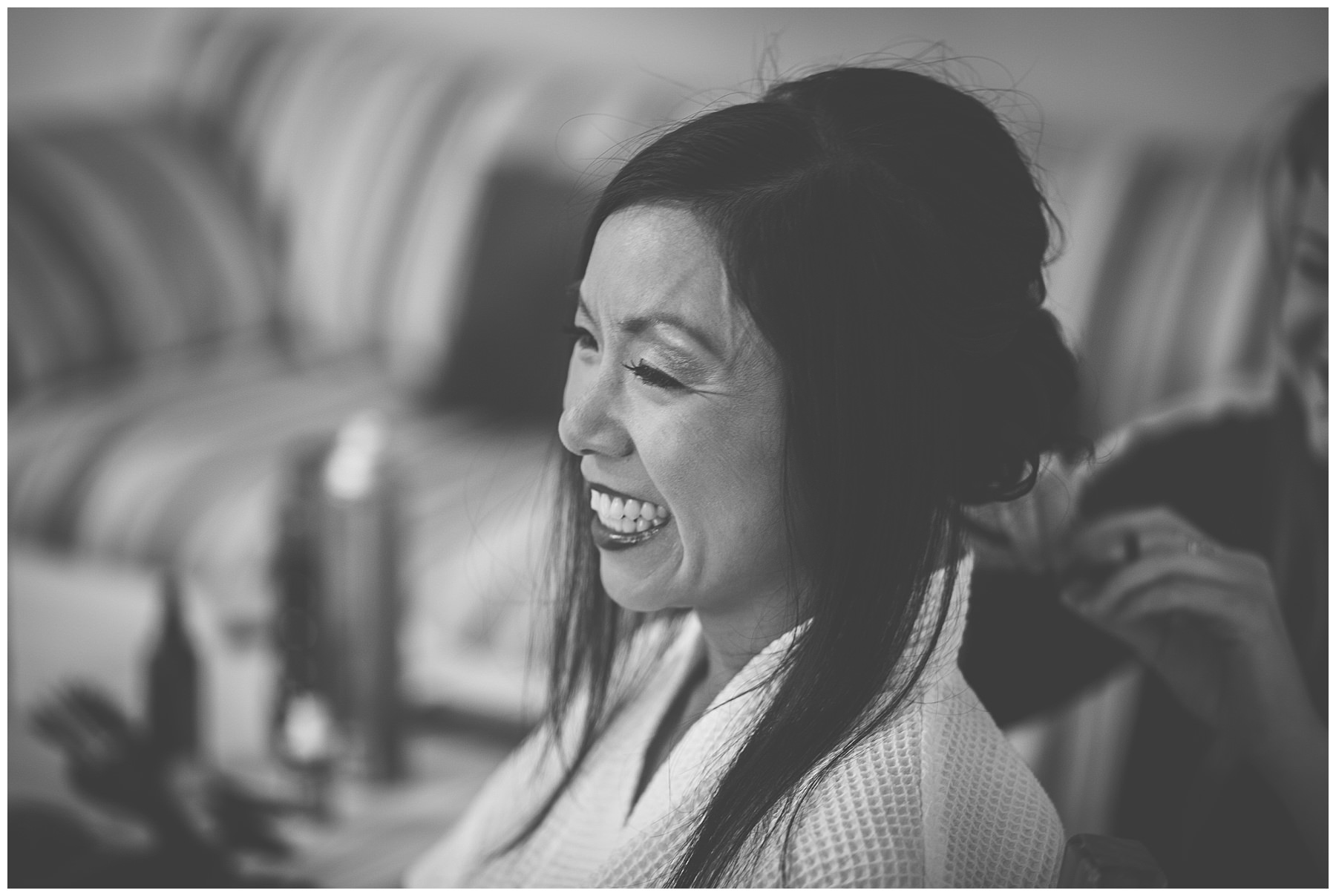 Bride smiles as she is having her hair done