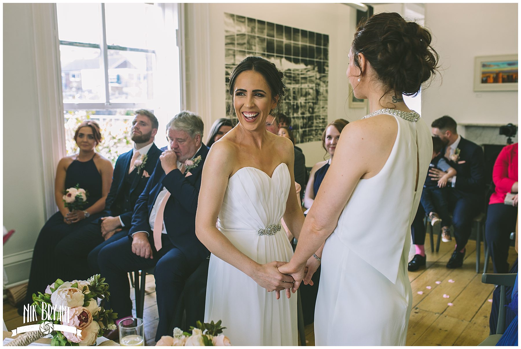 Brides hold hands during Lancashire same sex wedding
