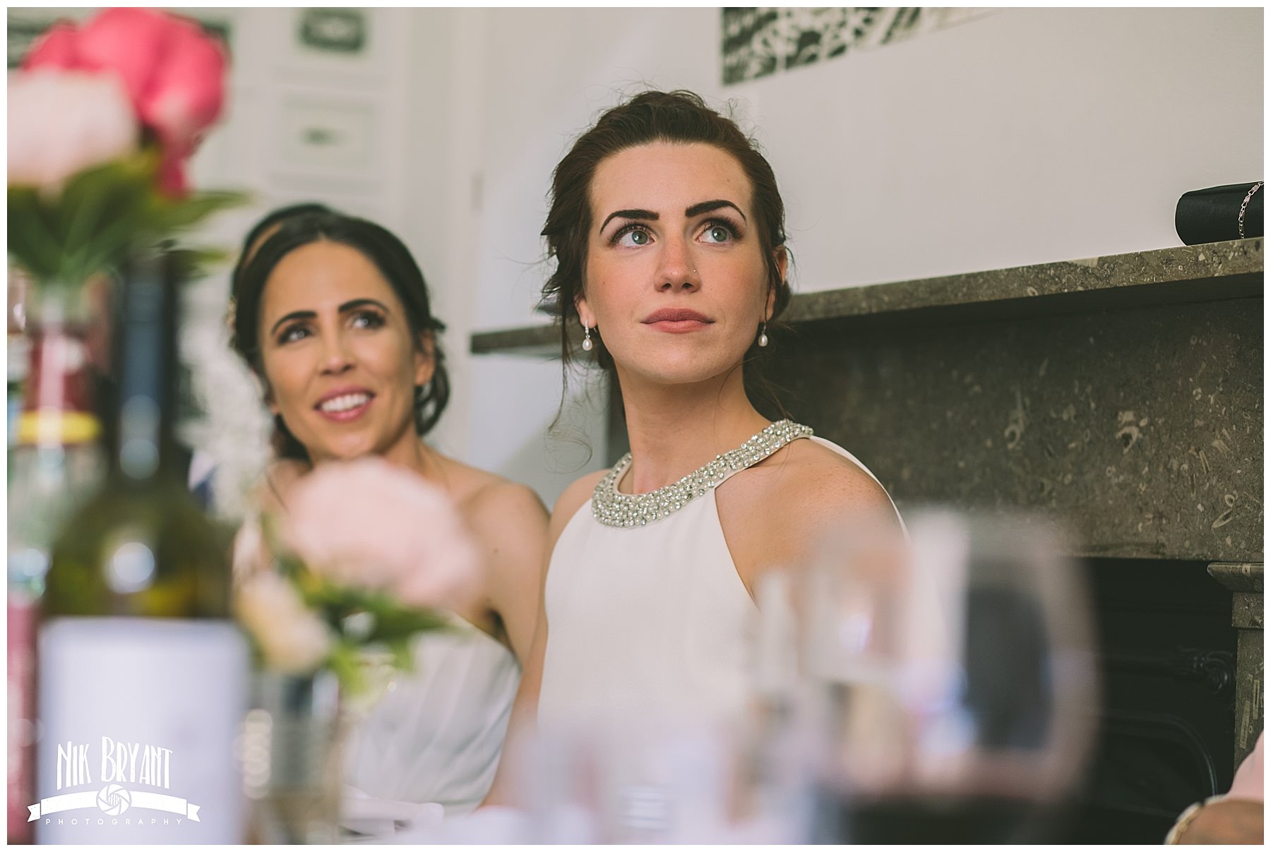 bride looks to her father during the speeches