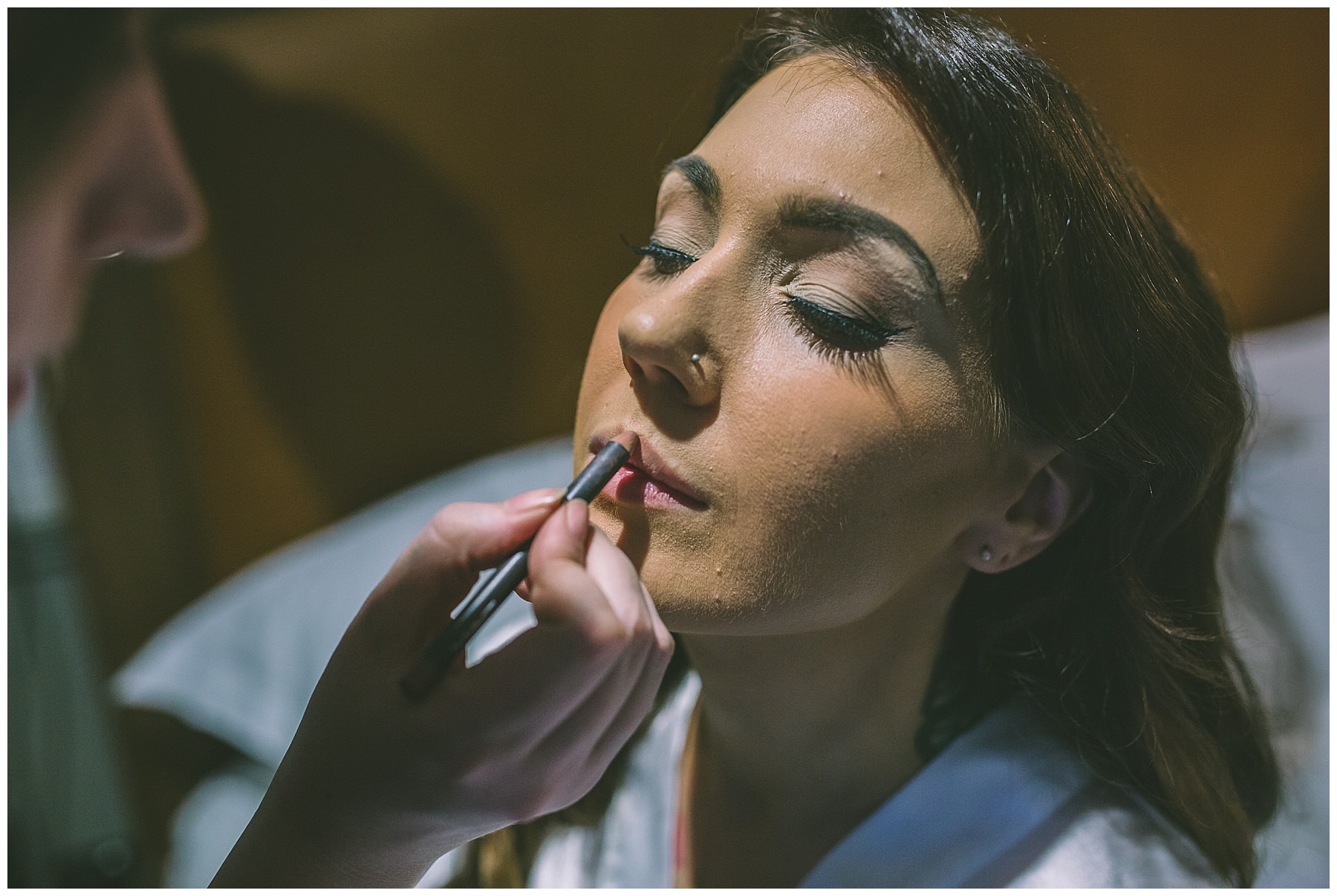 Bride has lip liner applied