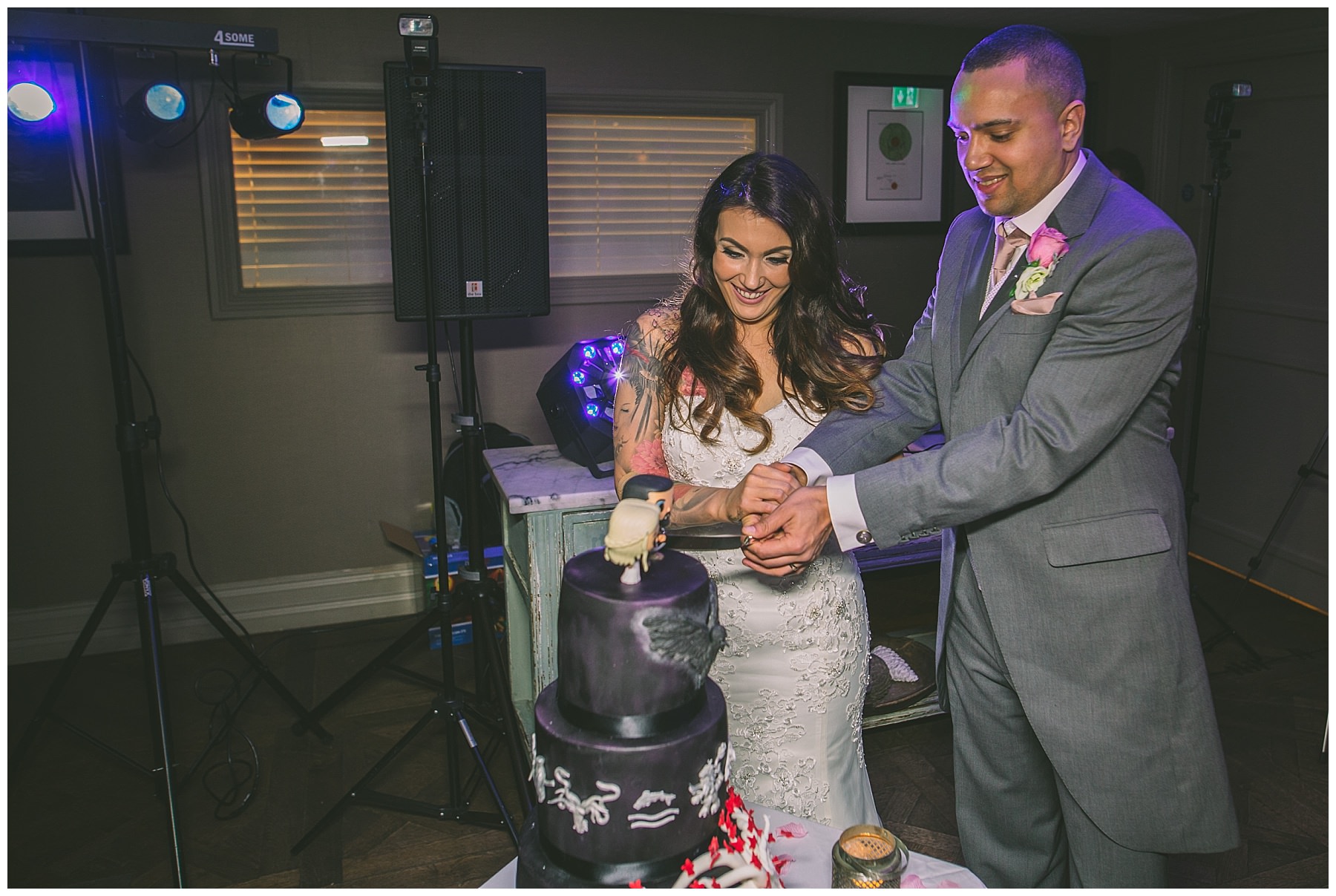 Bride and Groom cut into game of thrones wedding cake