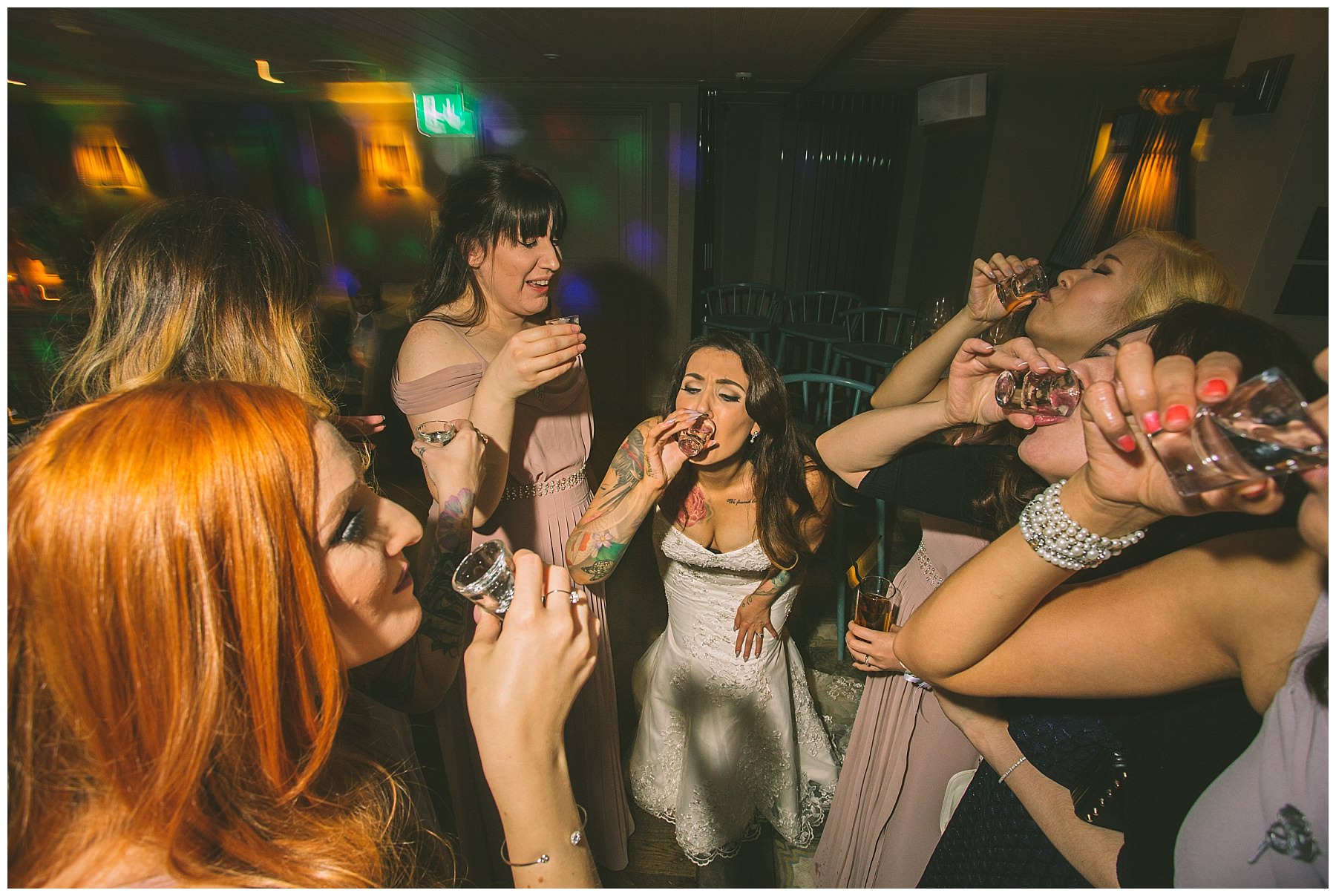 bride and bridesmaids do shots at winter wedding
