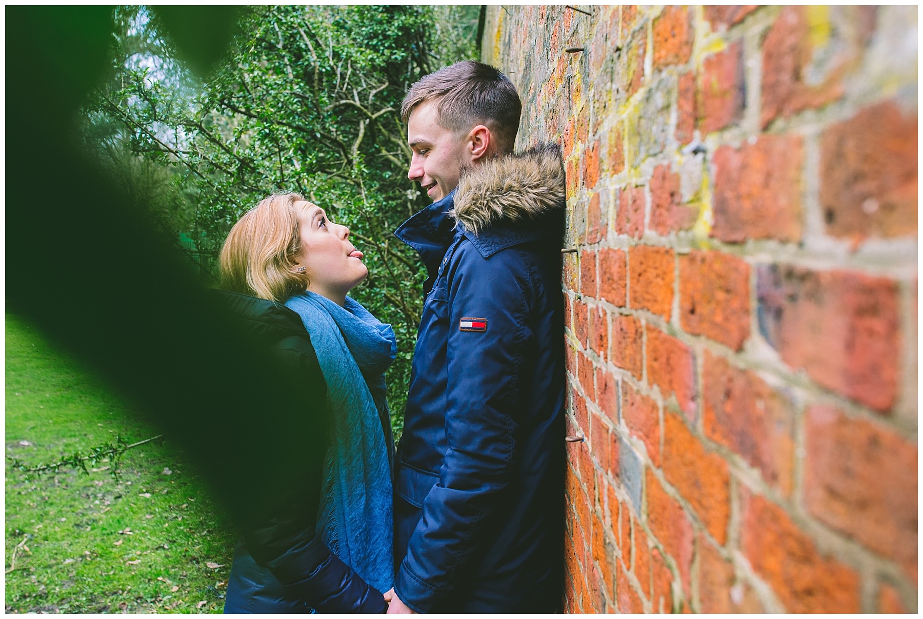 Engaged couple laugh and joke with each other during pre wedding shoot