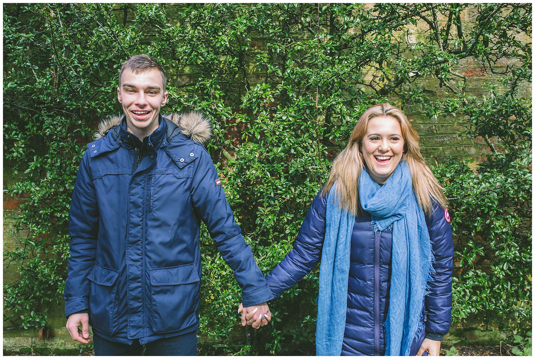 Couple holding hands share a giggle during the pre wedding shoot