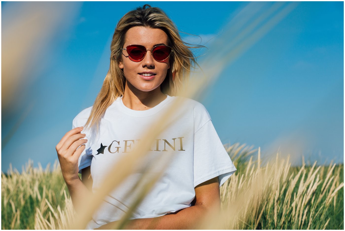 Model teases her hair in the sand dunes at Formby
