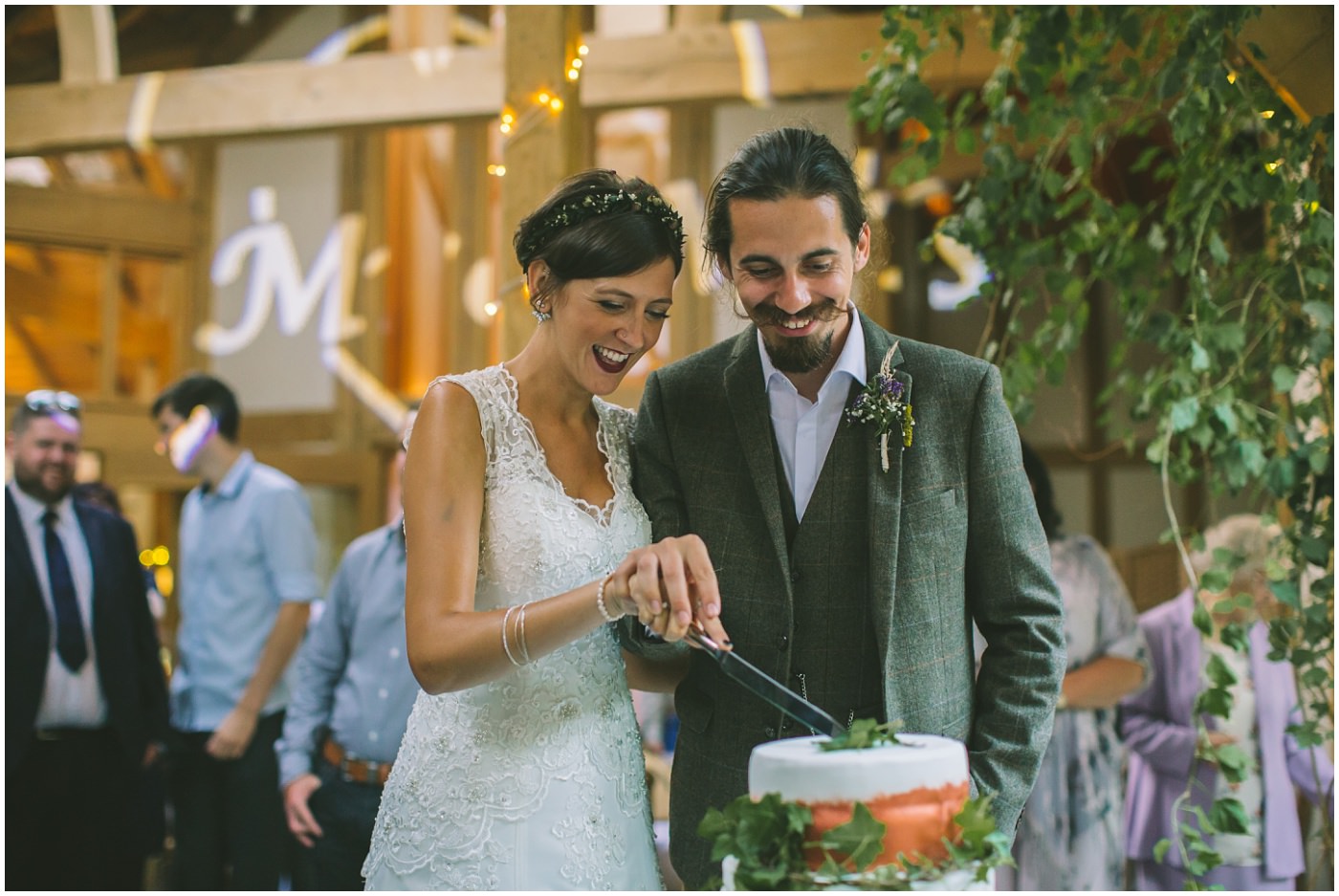 bride and groom cut the cake before their first dance