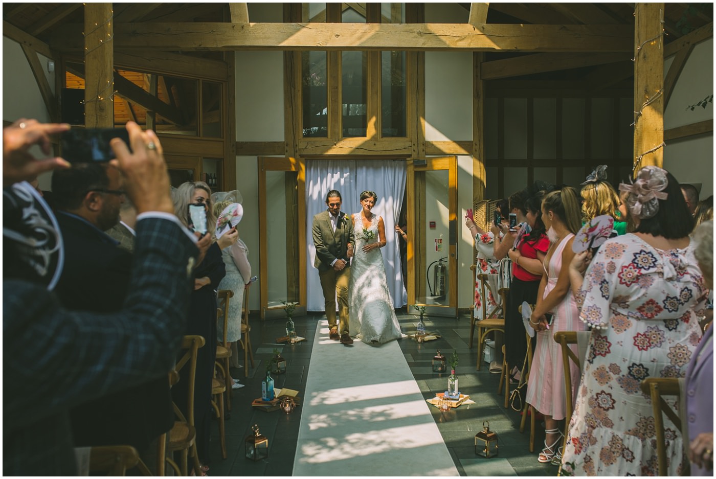 Bride and Groom walk down the isle together for the oaktree of peover wedding