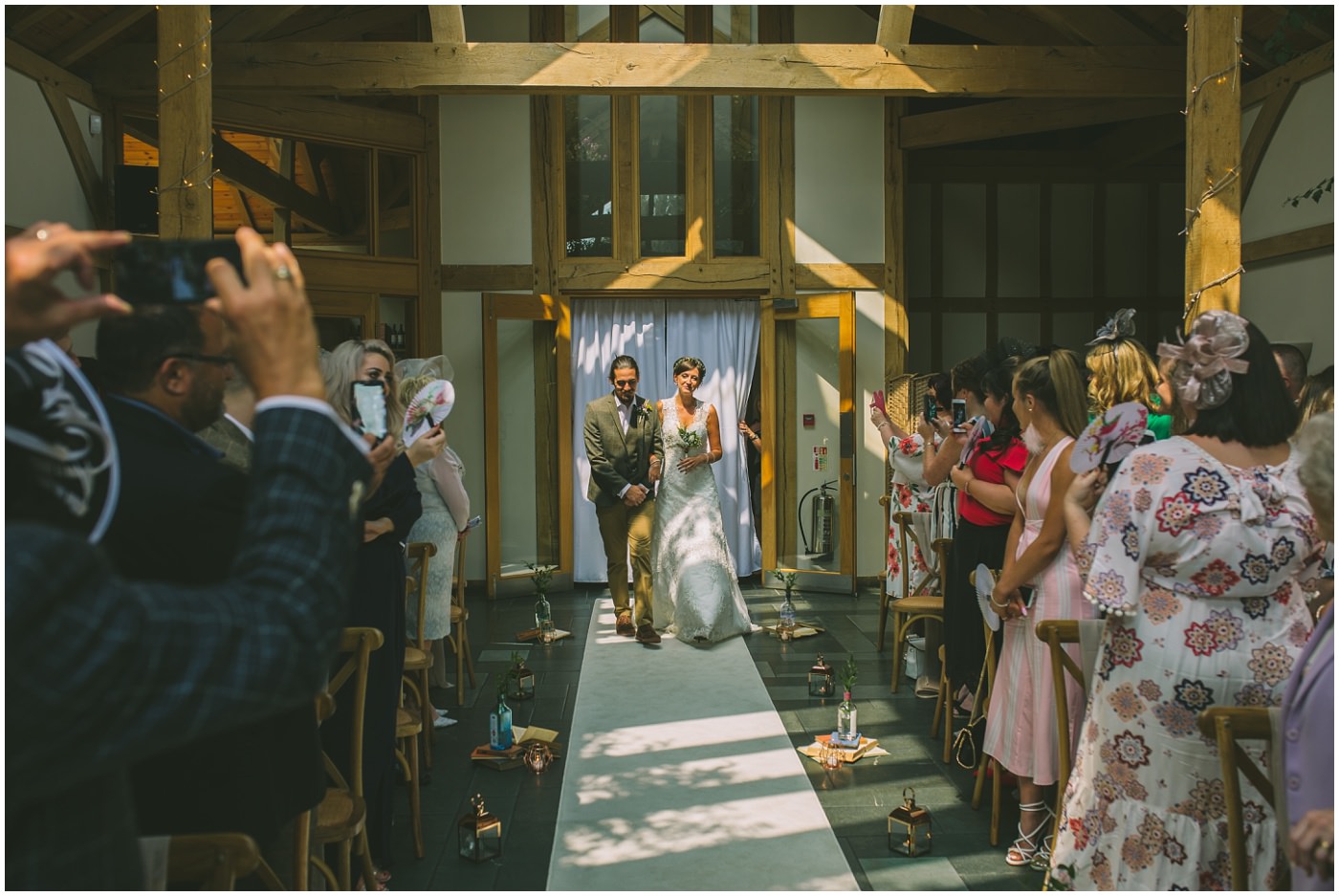Bride and Groom walk down the isle together for the oaktree of peover wedding