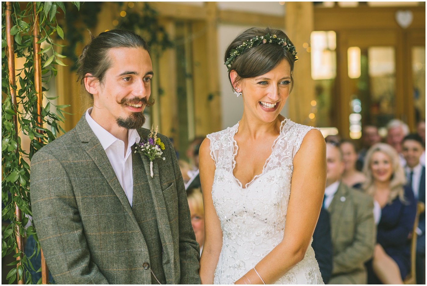 Bride and Groom smile during ceremony at the oaktree of peover