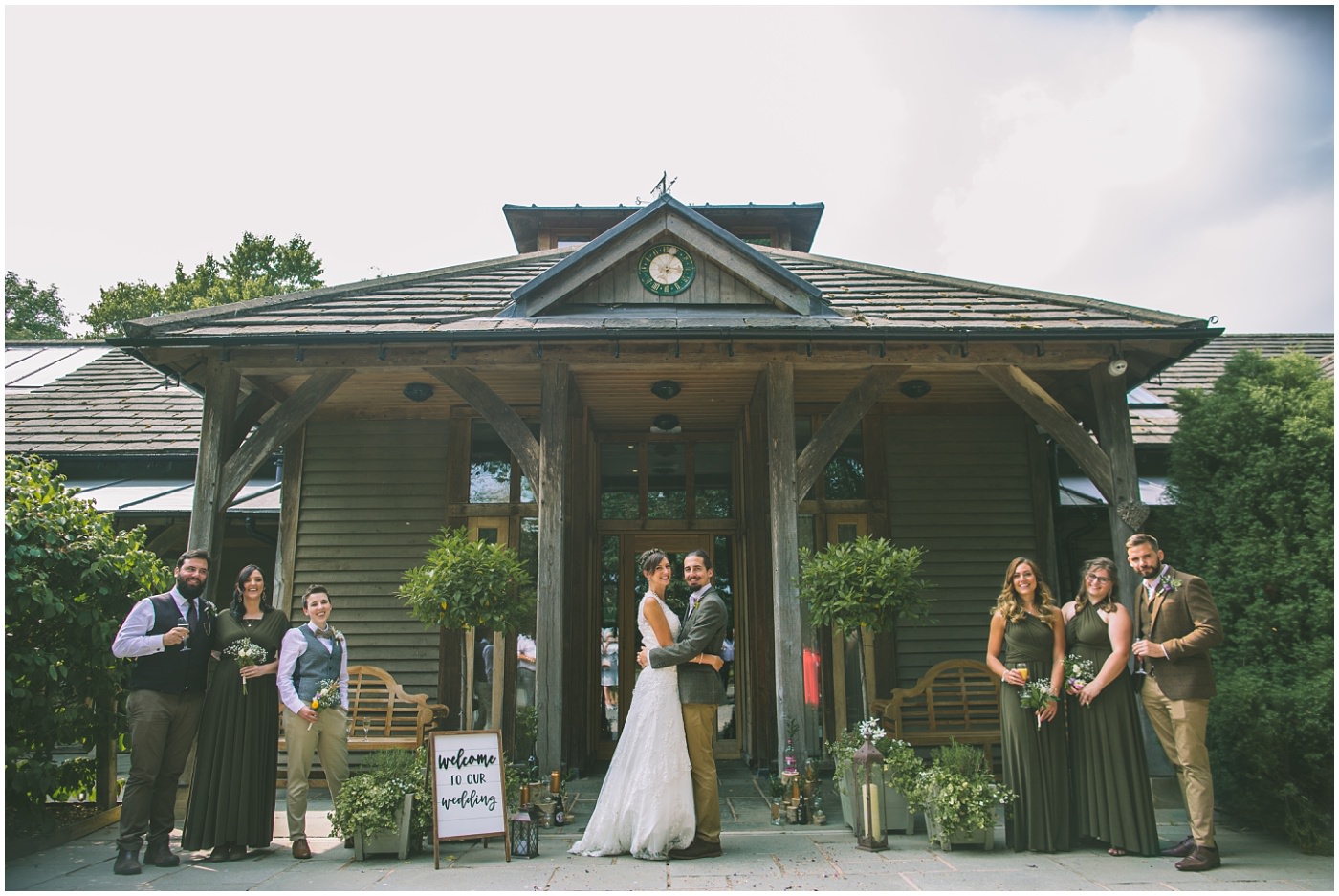 Bride and Groom and bridal party stand in front of the oak tree of peover