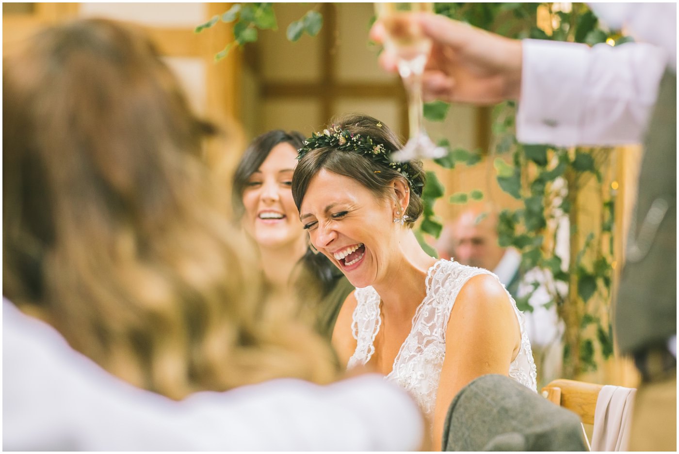 Bride laughing in reaction to speeches