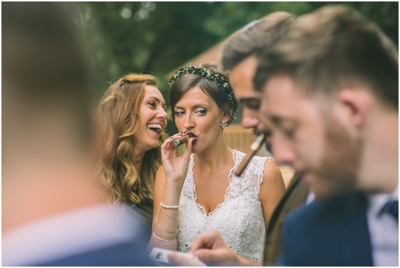 bride smoking a cigar during drinks reception