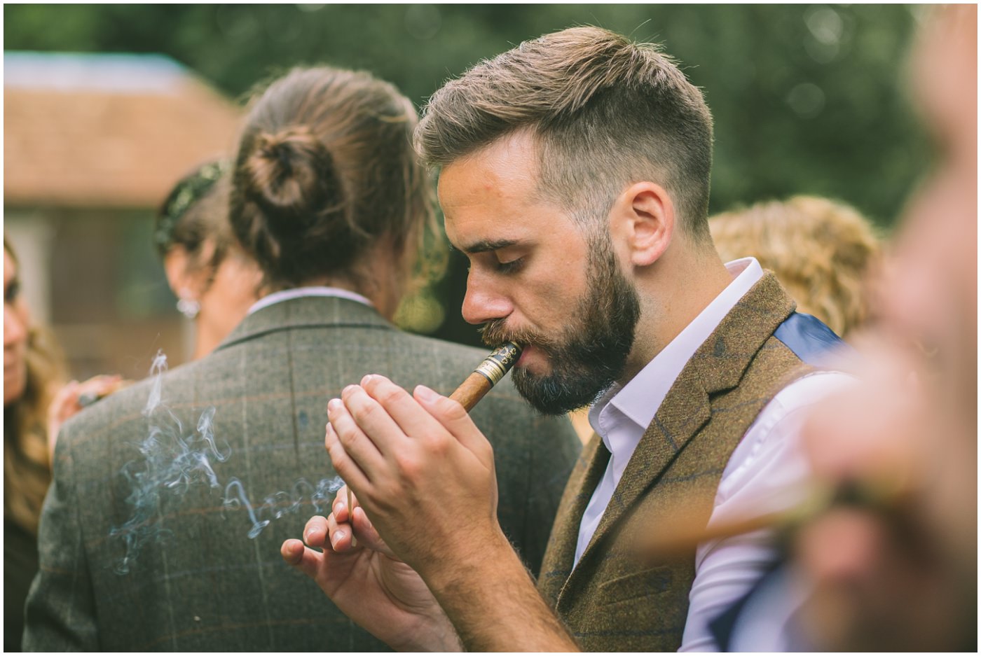 best man lights a cigar