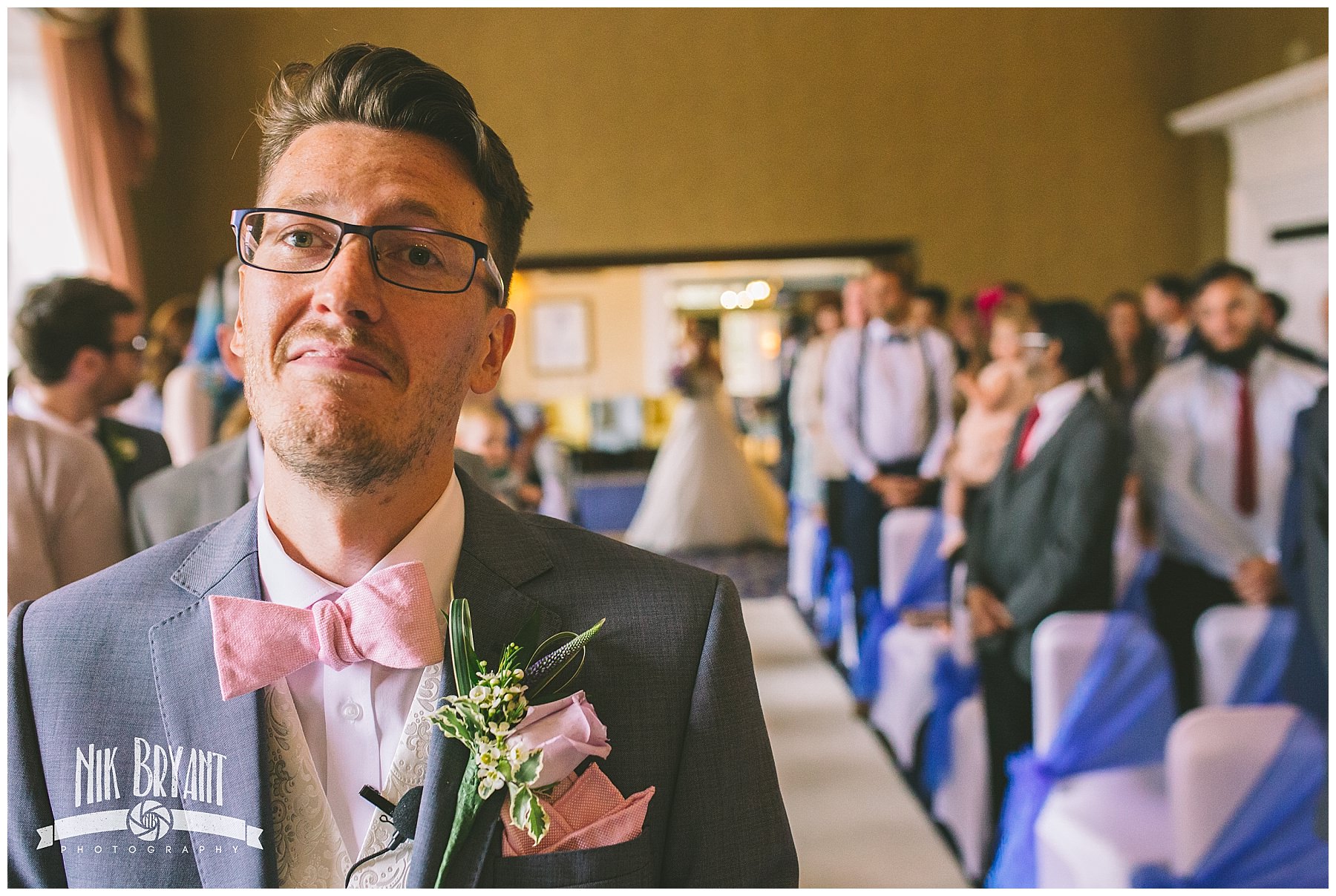 Groom nervously awaits bride to walk down the isle