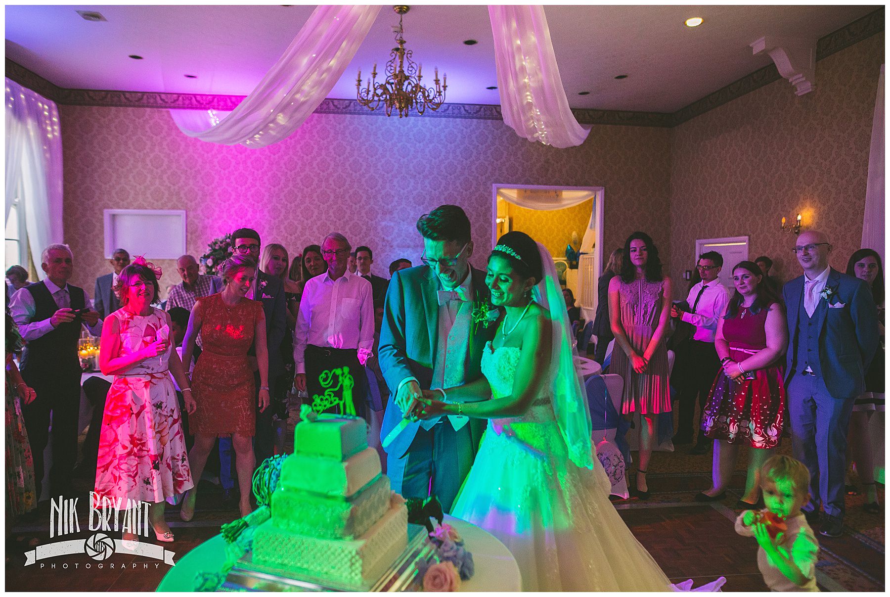 Bride and Groom cut the cake at shrigley hall