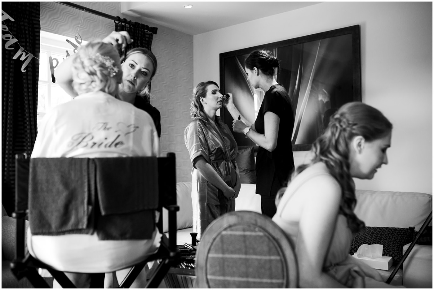 busy bridal prep scene with multiple bridesmaids getting ready