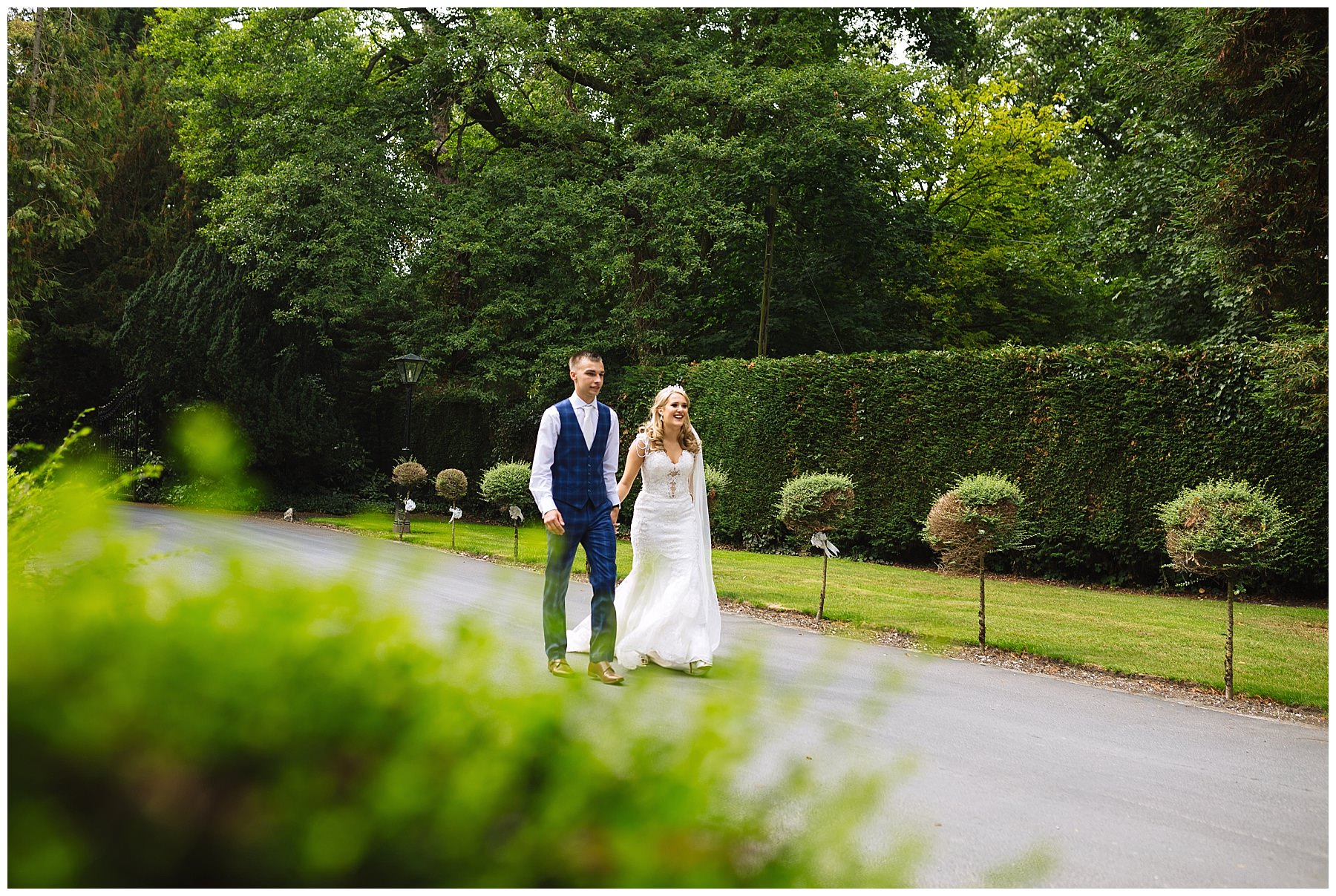 married couple walk up the drive at bartle hall