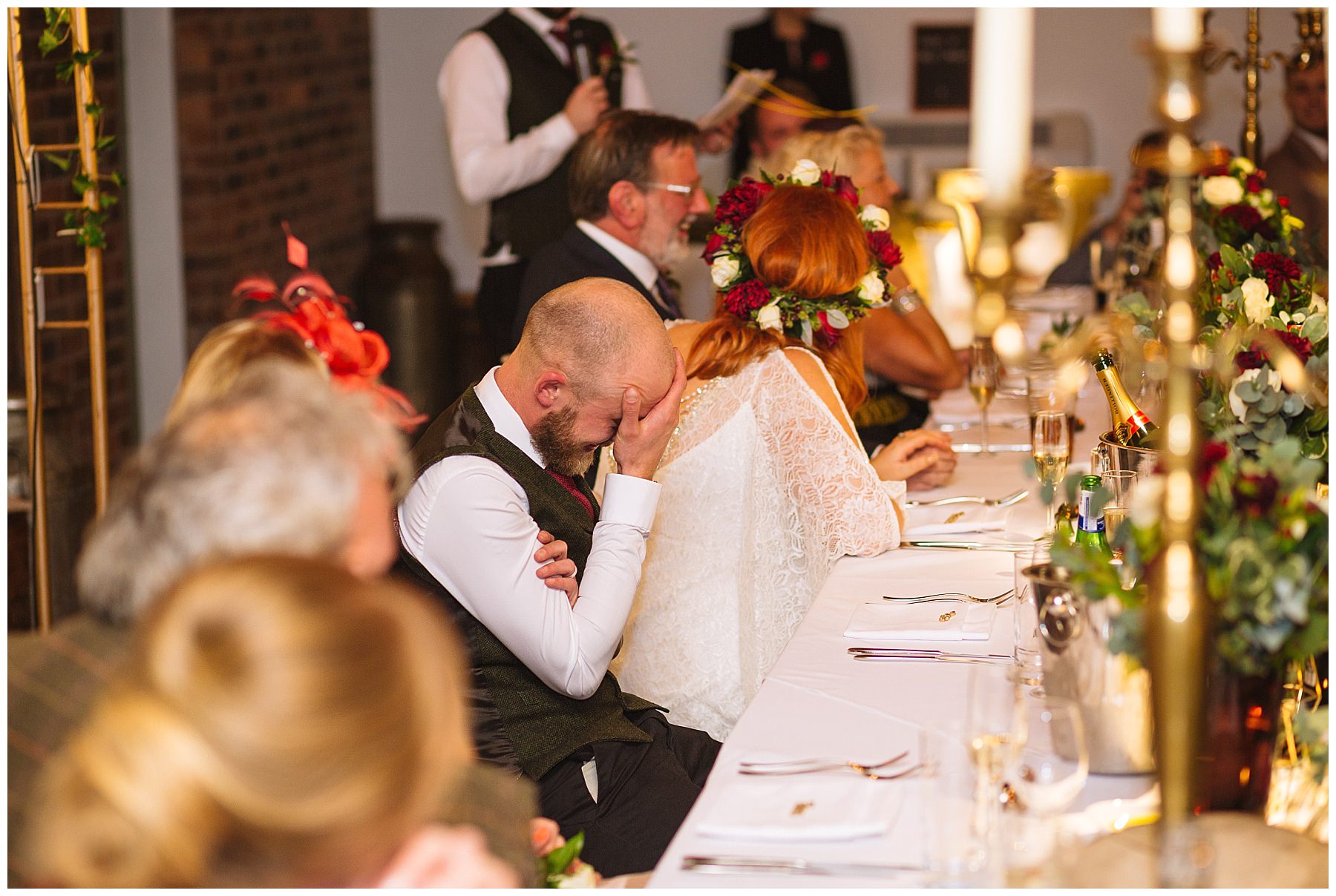 Groom hies head in hands during best mans speech