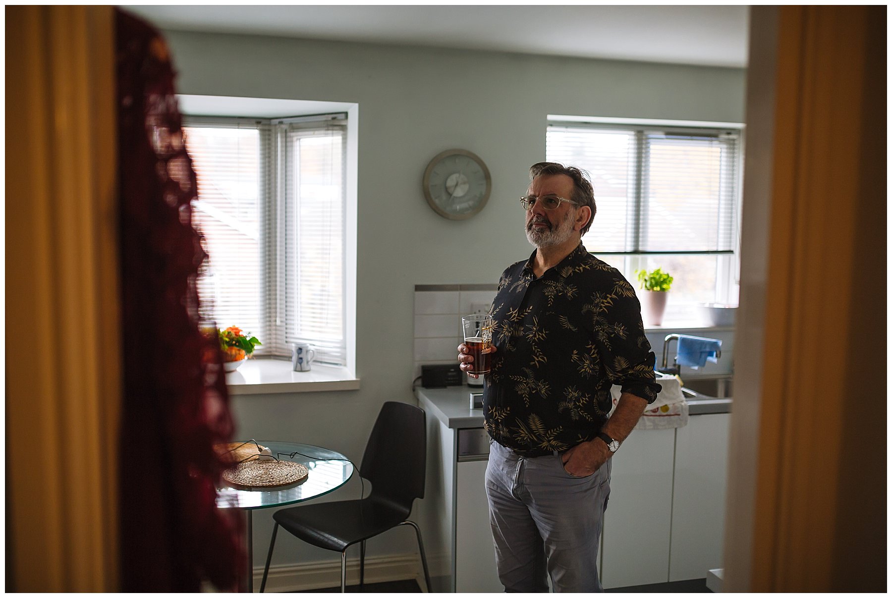 Father of the bride looks at bridesmaid dress