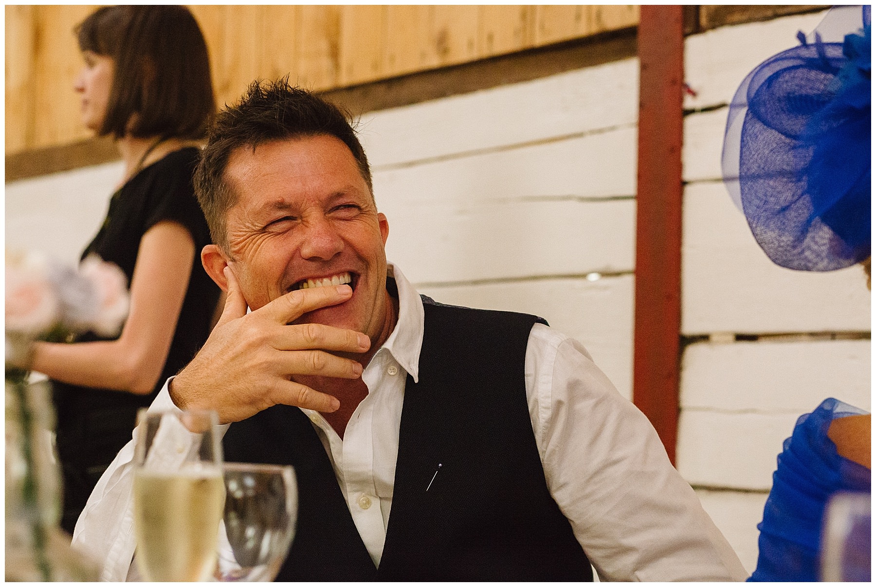 father of the bride laughs during speeches