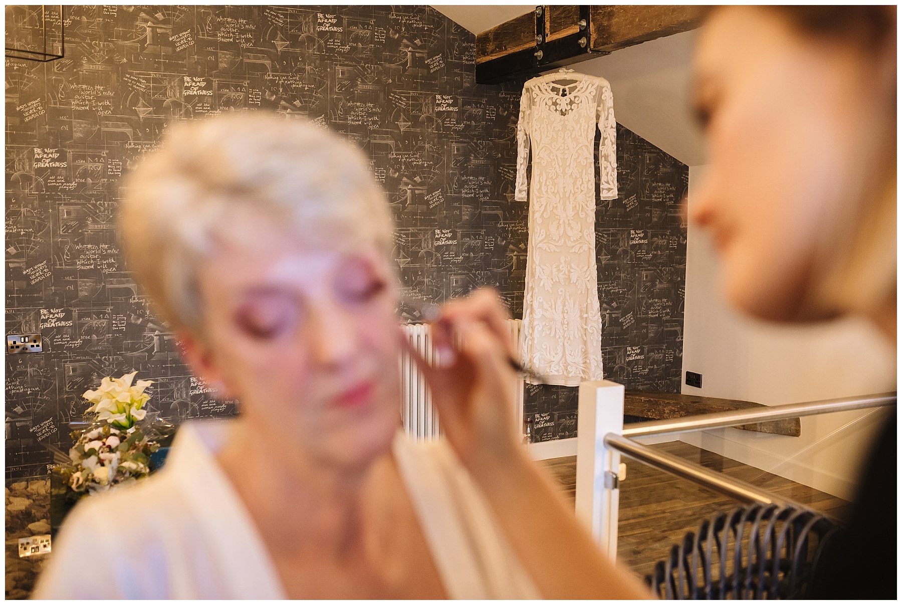 Lace wedding dress hangs during bridal prep