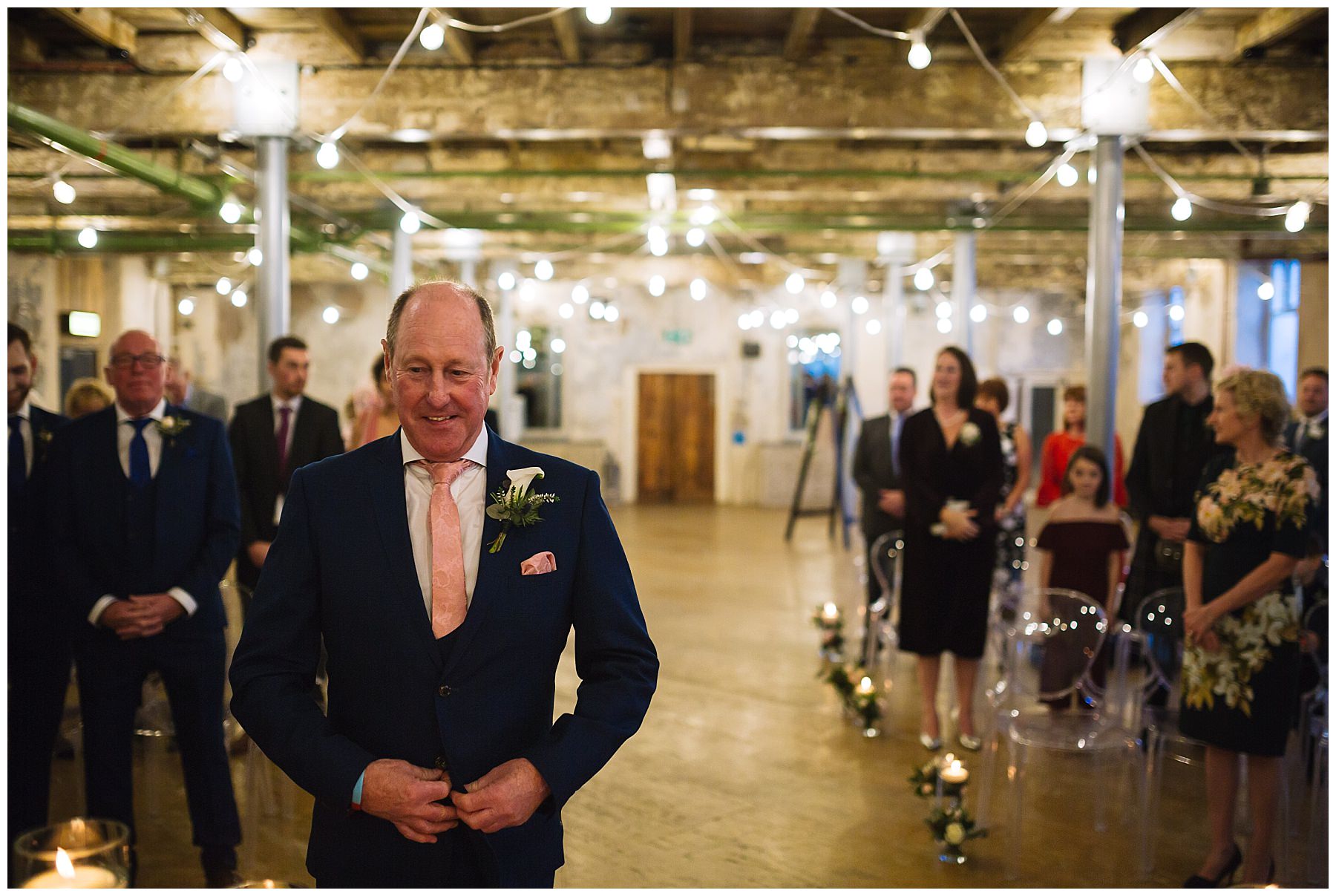 Groom awaiting his bride in the ceremony room at Holmes Mill