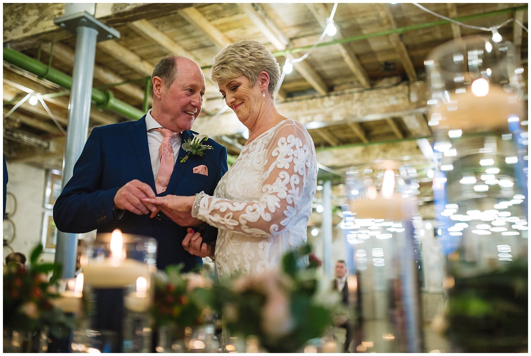 Bride and Groom exchange wedding rings during ceremony at holmes mill