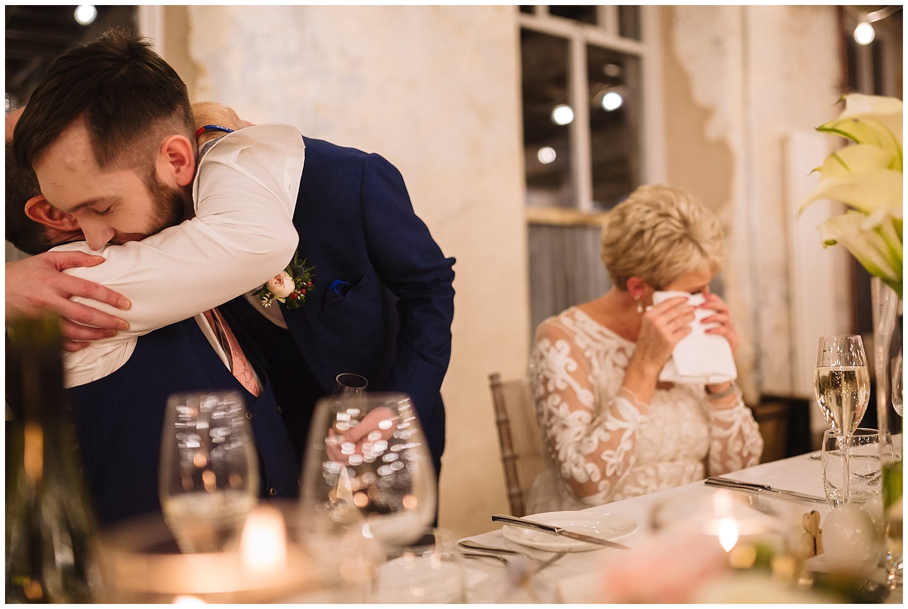 Son hugs dad while bride sheds a tear