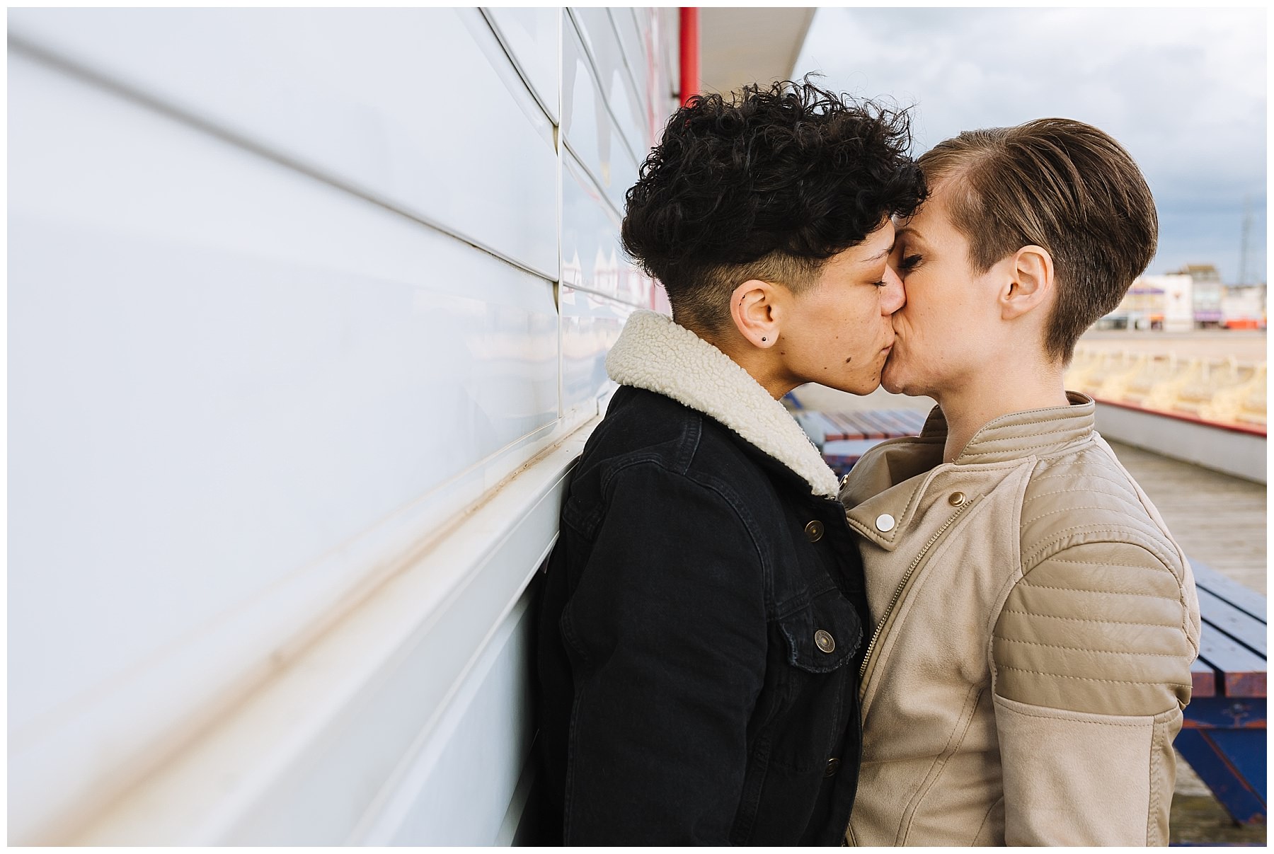 Couple kiss on central pier during pre wedding shoot