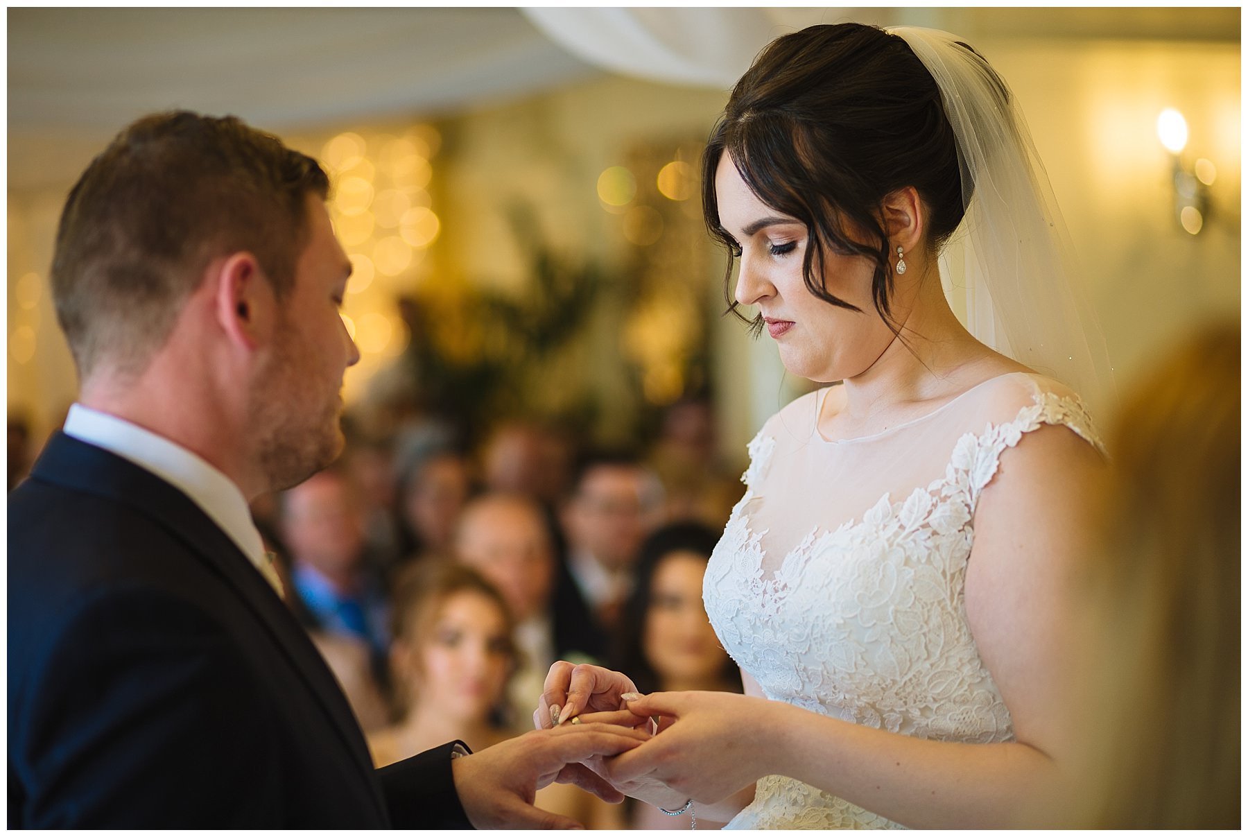 Bride and Groom exchange wedding rings at eaves hall