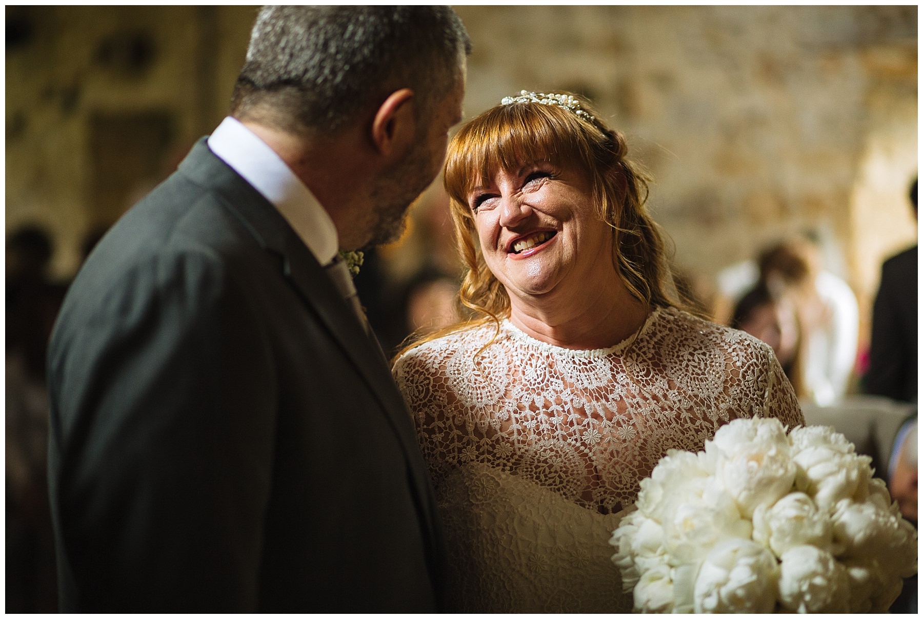 Bride smiles during beautiful wedding ceremony at healey barn