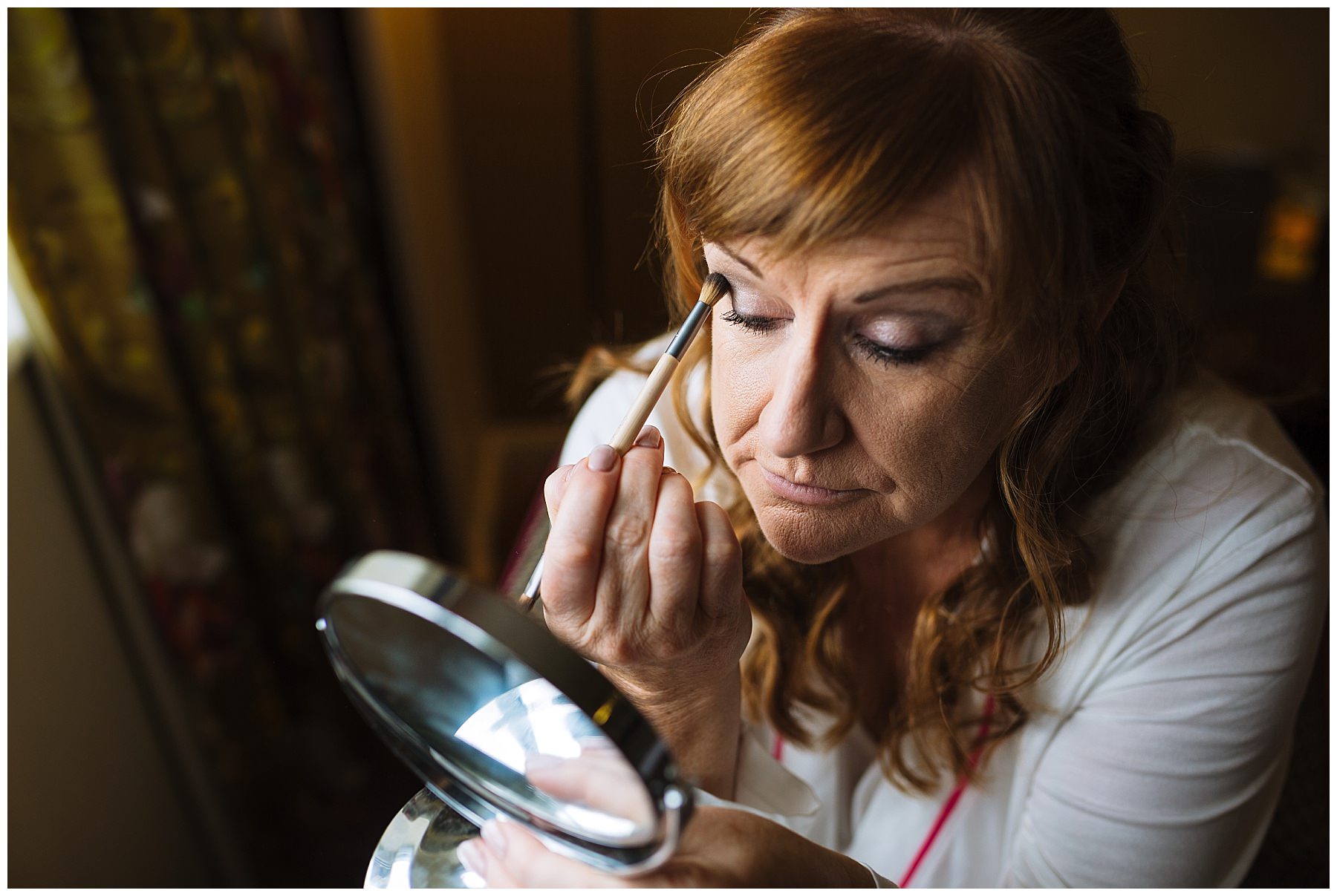 Bride applies make up for healey barn wedding