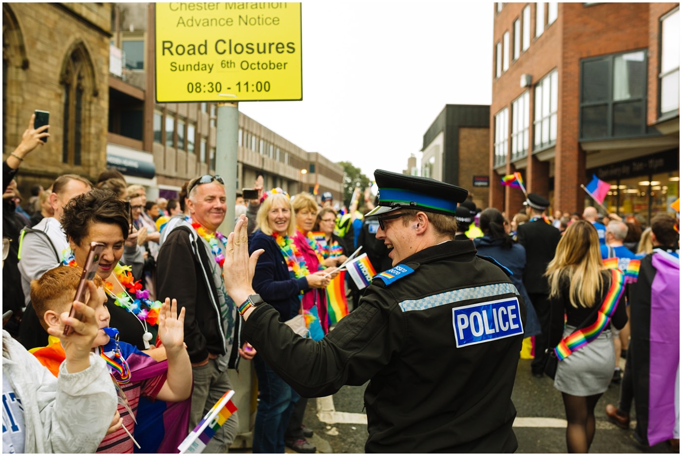 Police officer at pride high fives the crowd