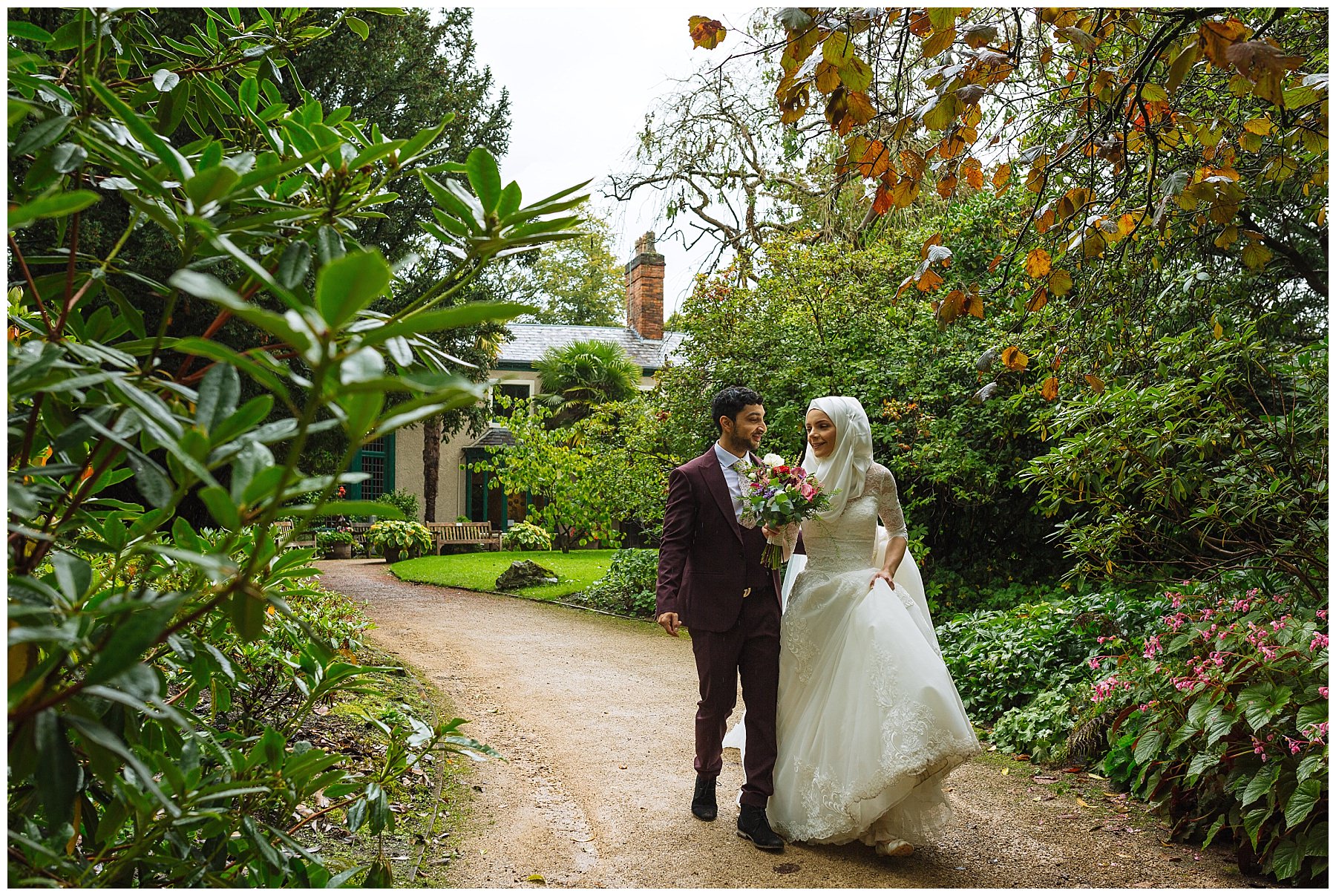 Married couple take a walk through the gardens of the old parsonage in Didsbury