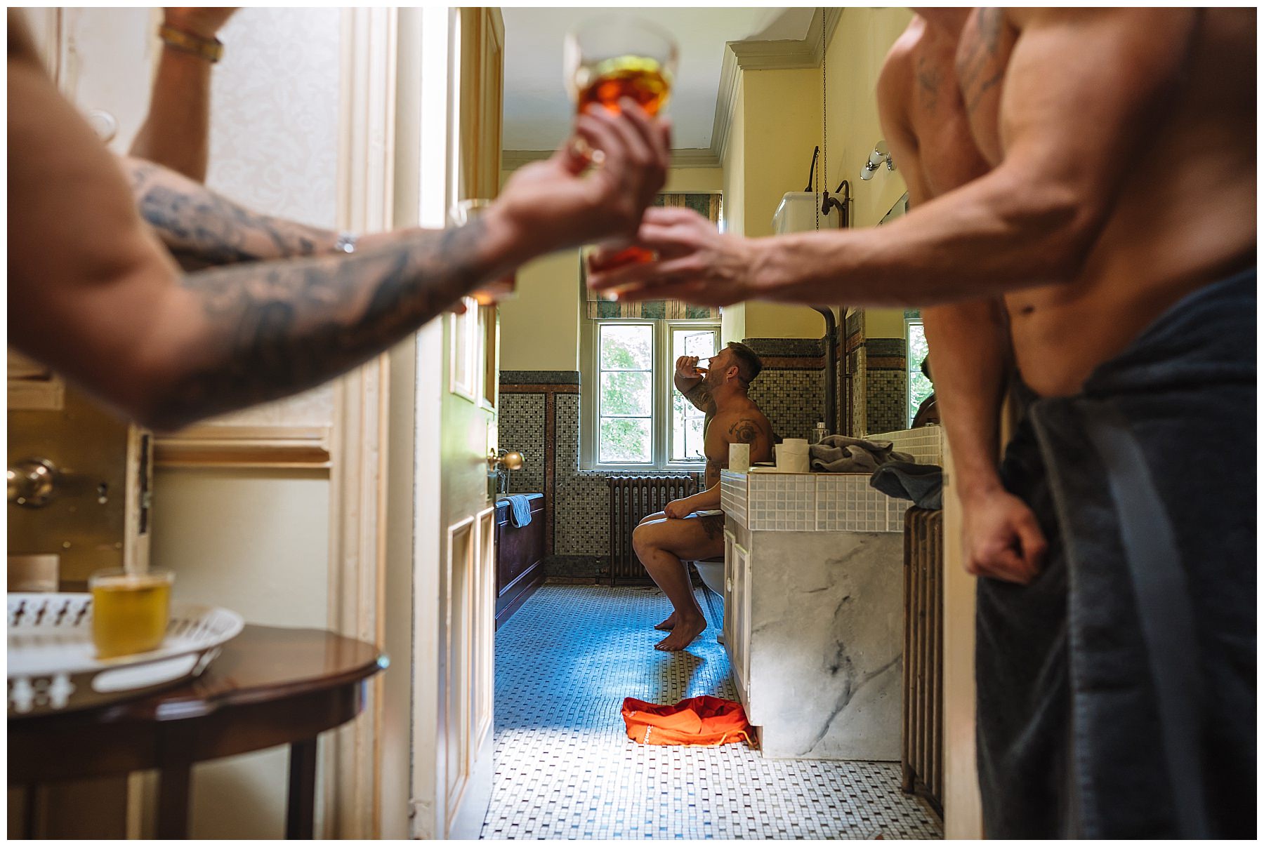 groomsmen doing shots while on toilet