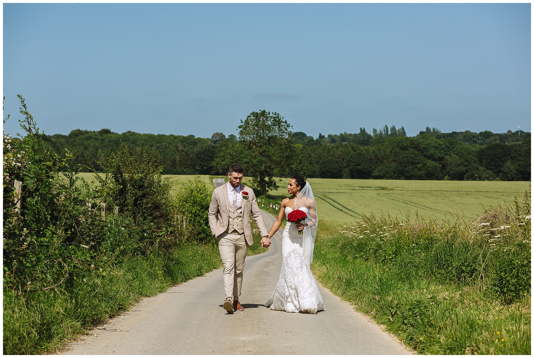 couple walk hand in hand through the grounds at swancar farm