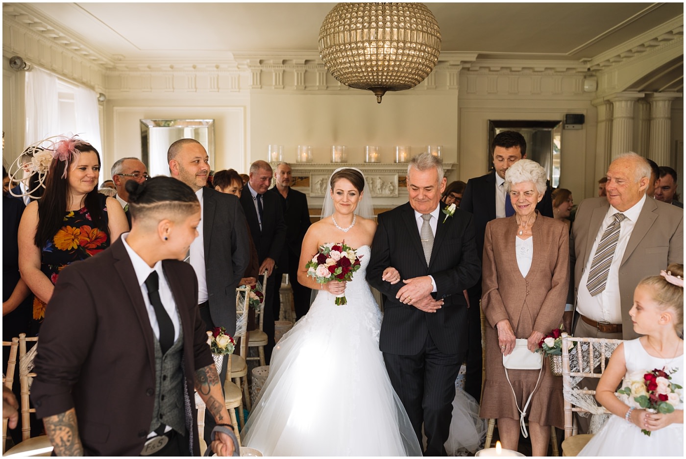 Bride and Father walk down the aisle in Eaves Hall Ballroom