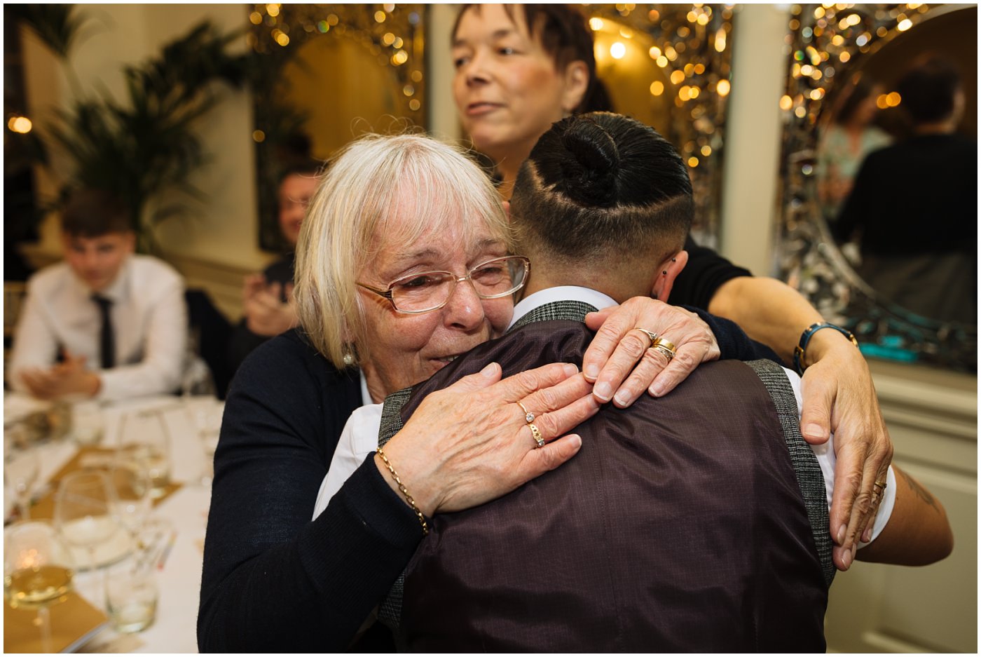 Bride hugs family during wedding games and speeches