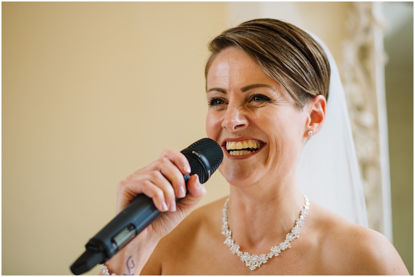 bride speaks to guests during wedding breakfast