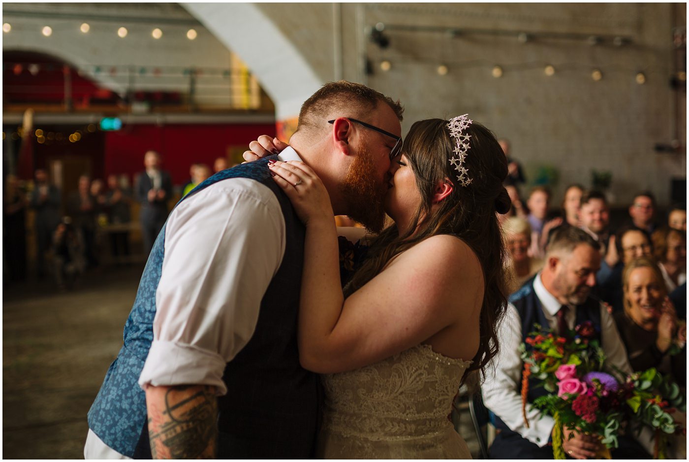 Bride and Grooms First Kiss at Tattooed Alternative Wedding