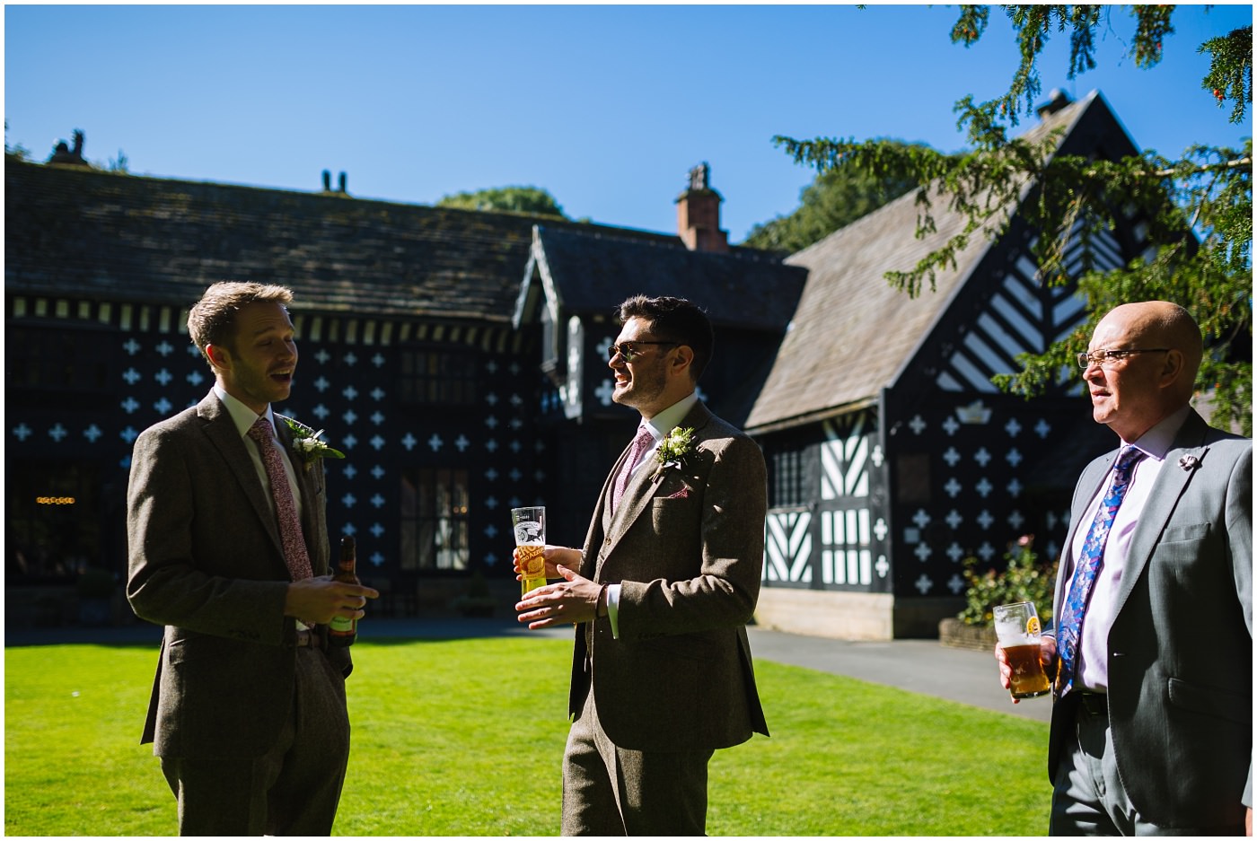 groom and groomsmen in the sun at Samlesbury hall