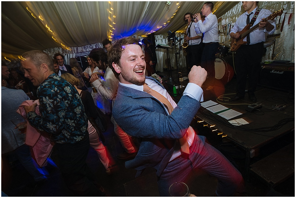 groom enjoying wedding party and wedding band